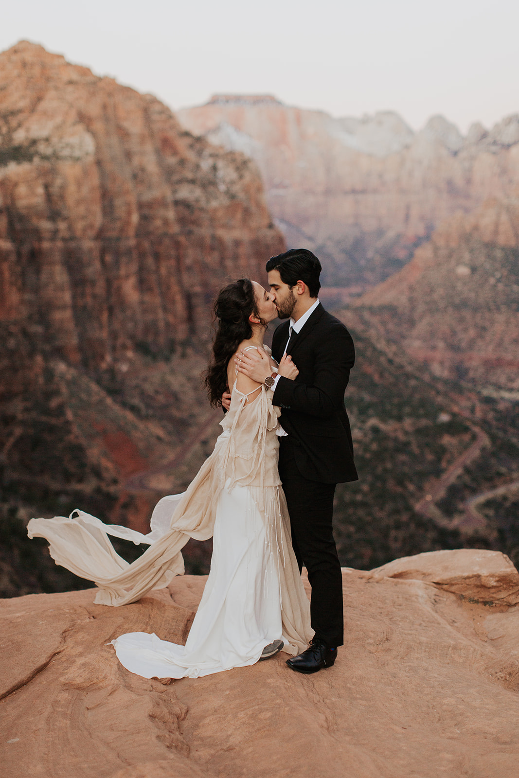 couple elopes on overlook at Zion National Park wedding 