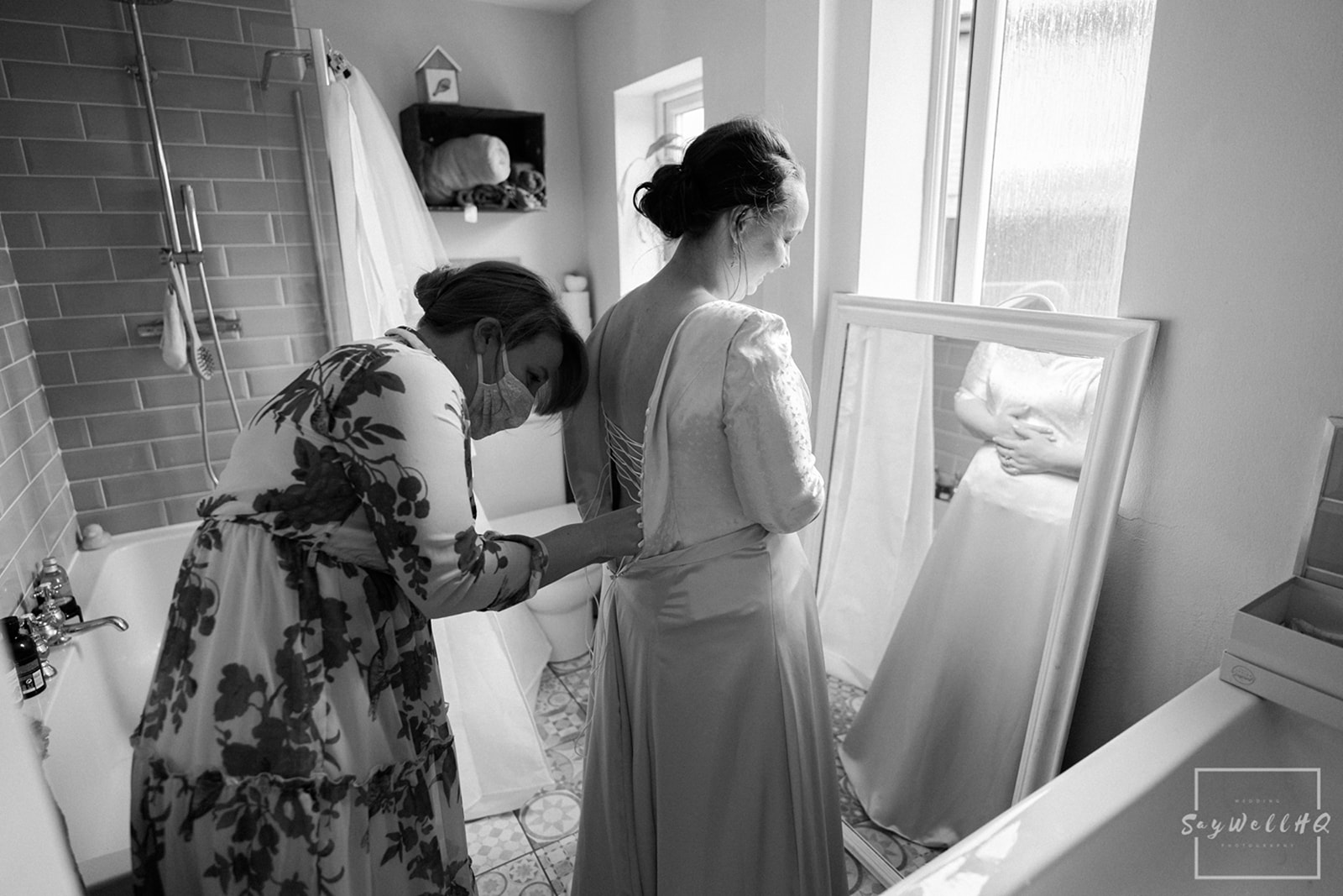 Newark Registry Office Wedding Photography - bride getting helped into her wedding dress