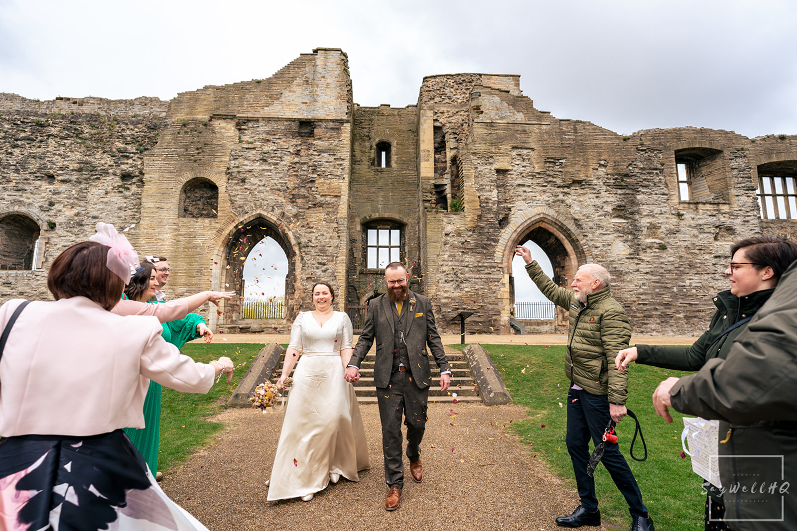 Newark Registry Office Wedding Photography - bride and groom get covered in confetti in the Newark castle grounds