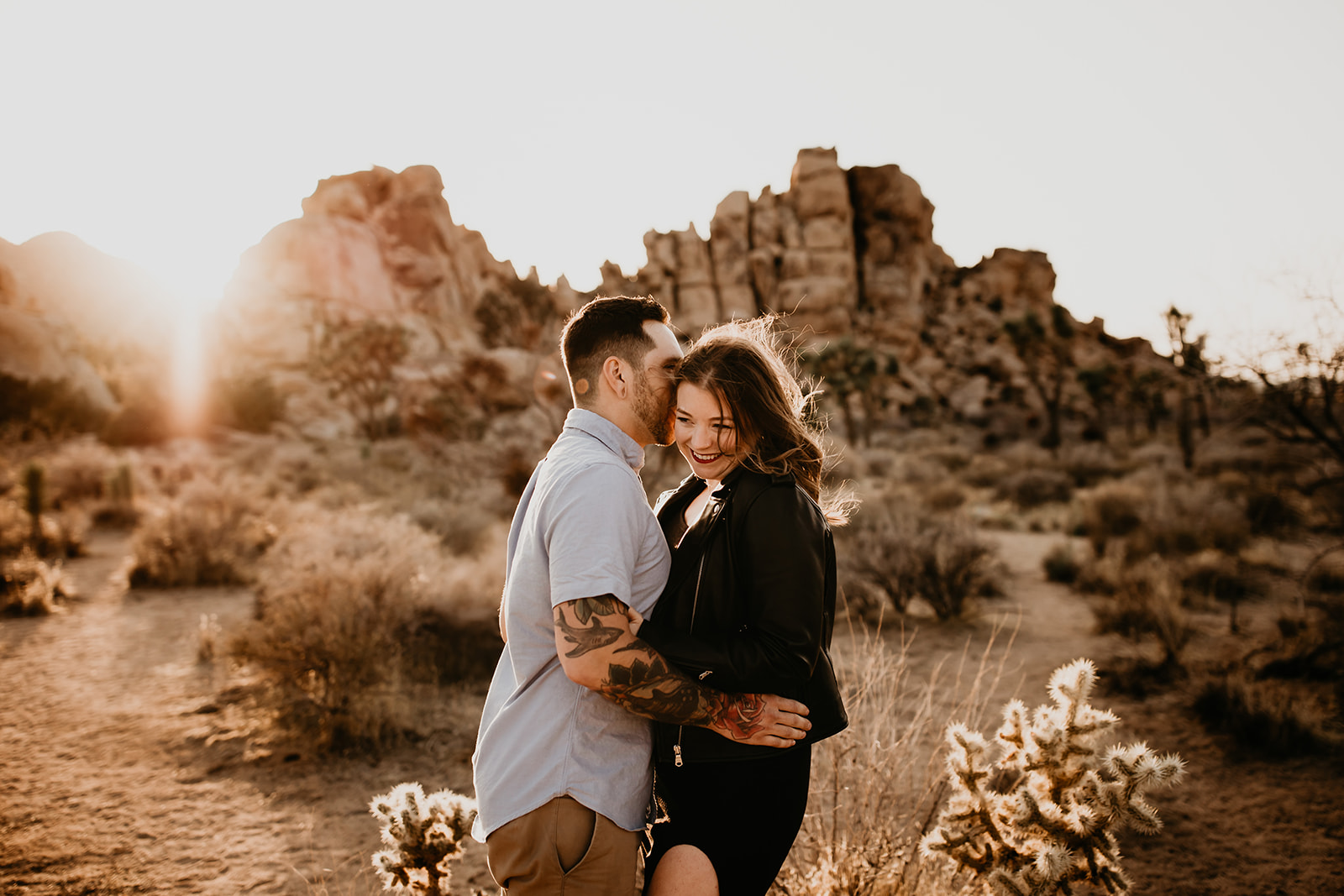 a couple embraces in Joshua Tree, California for their engagement session