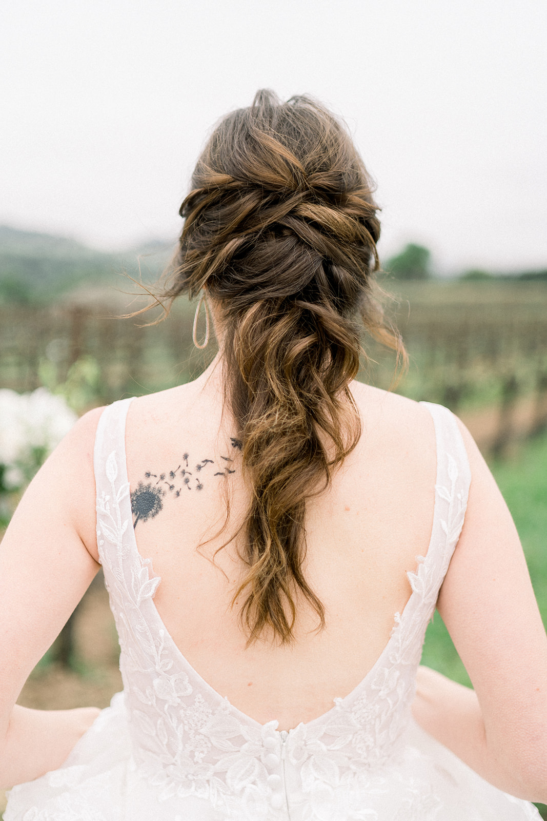 Bride's stunning updo with delicate hairpiece, photographed at Sunstone Winery by Tiffany Longeway, Southern California 