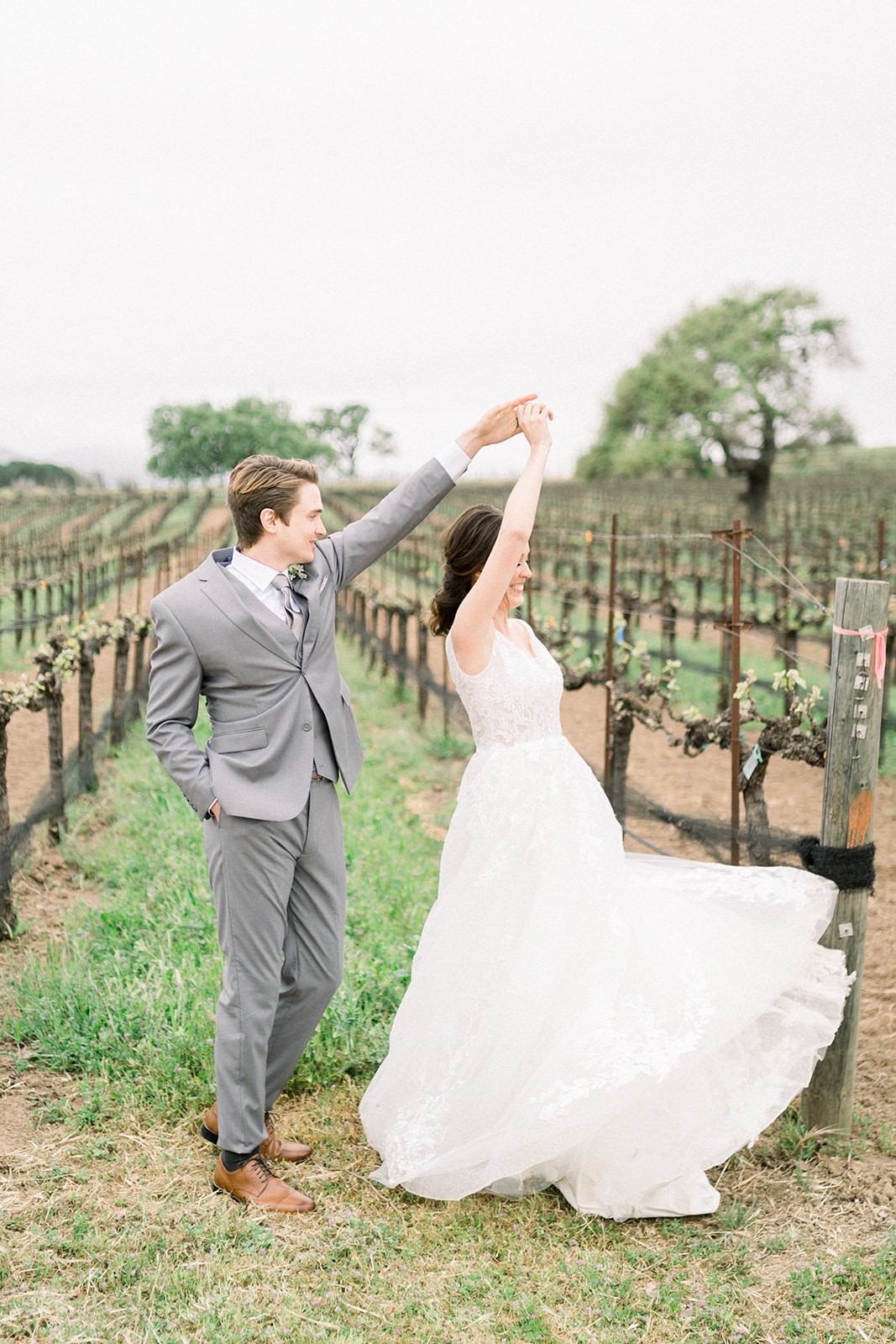 Candid luxury wedding moment at Sunstone Winery, with Southern California’s hills in the backdrop.