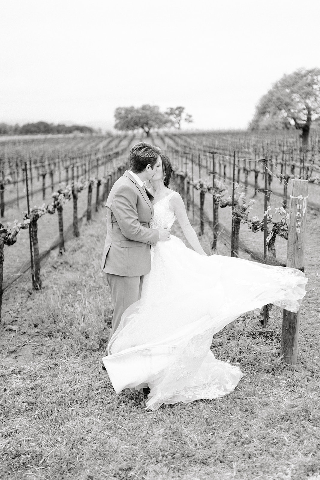 Candid luxury wedding moment at Sunstone Winery, with Southern California’s hills in the backdrop.