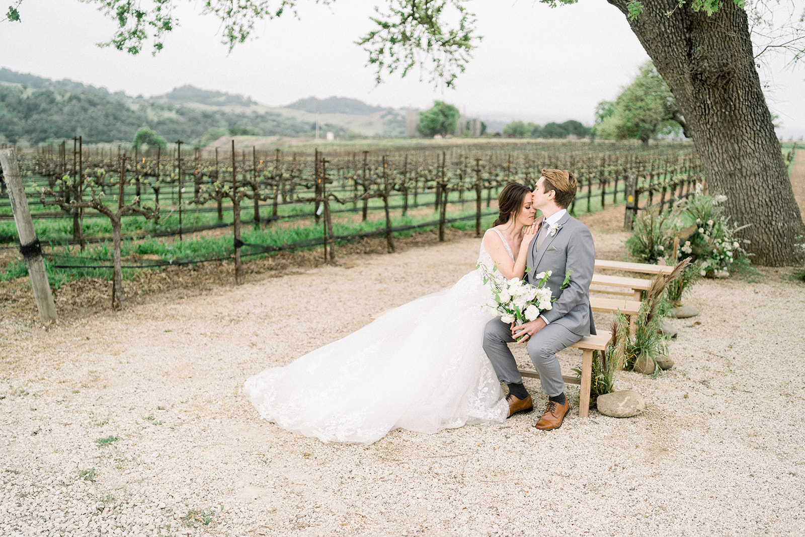 Luxurious Sunstone Winery wedding ceremony setup with with Southern California's oak trees framing the aisle.
