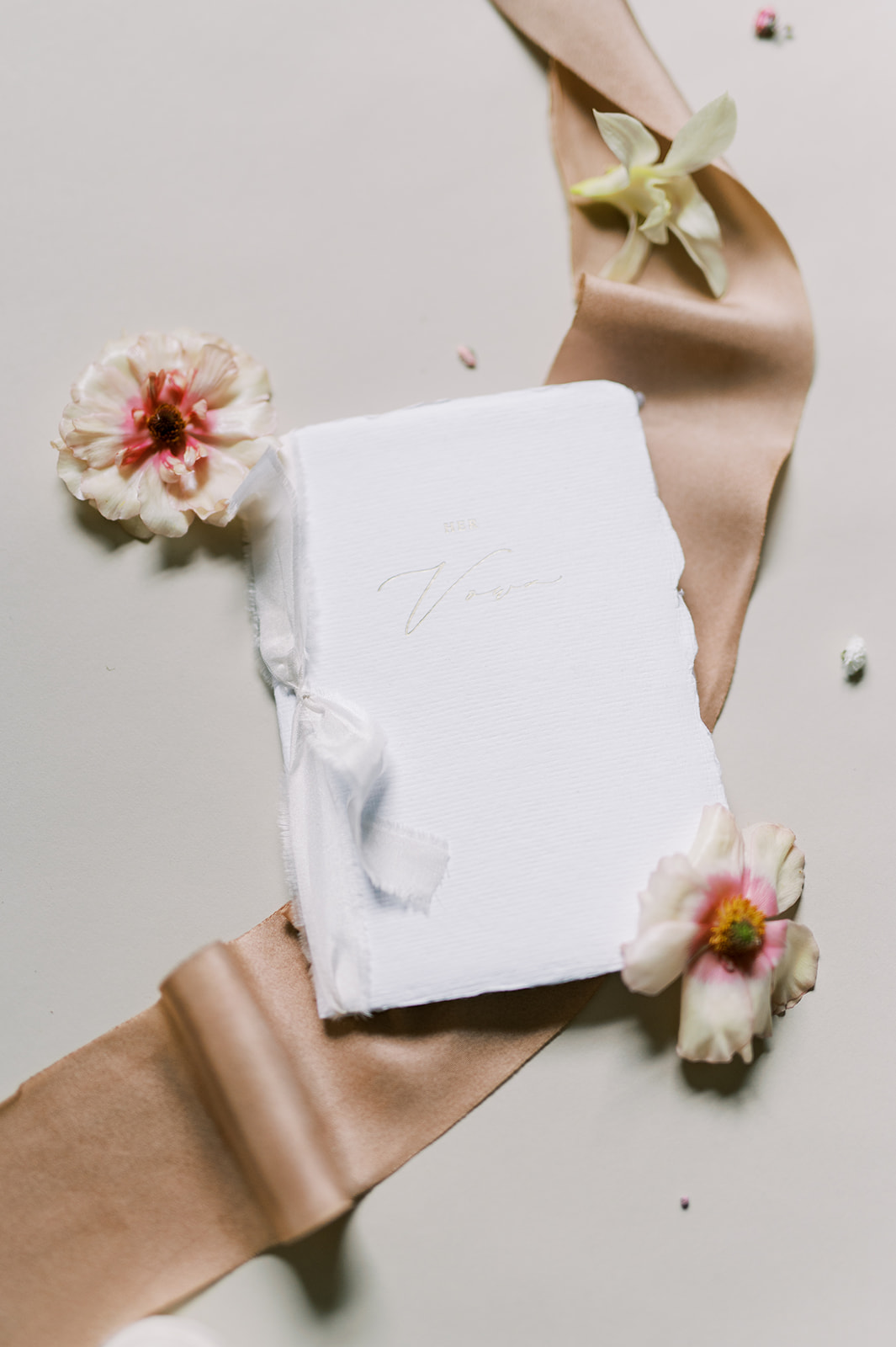 Custom-made vow book for bride with pink butterfly ranunculus flowers