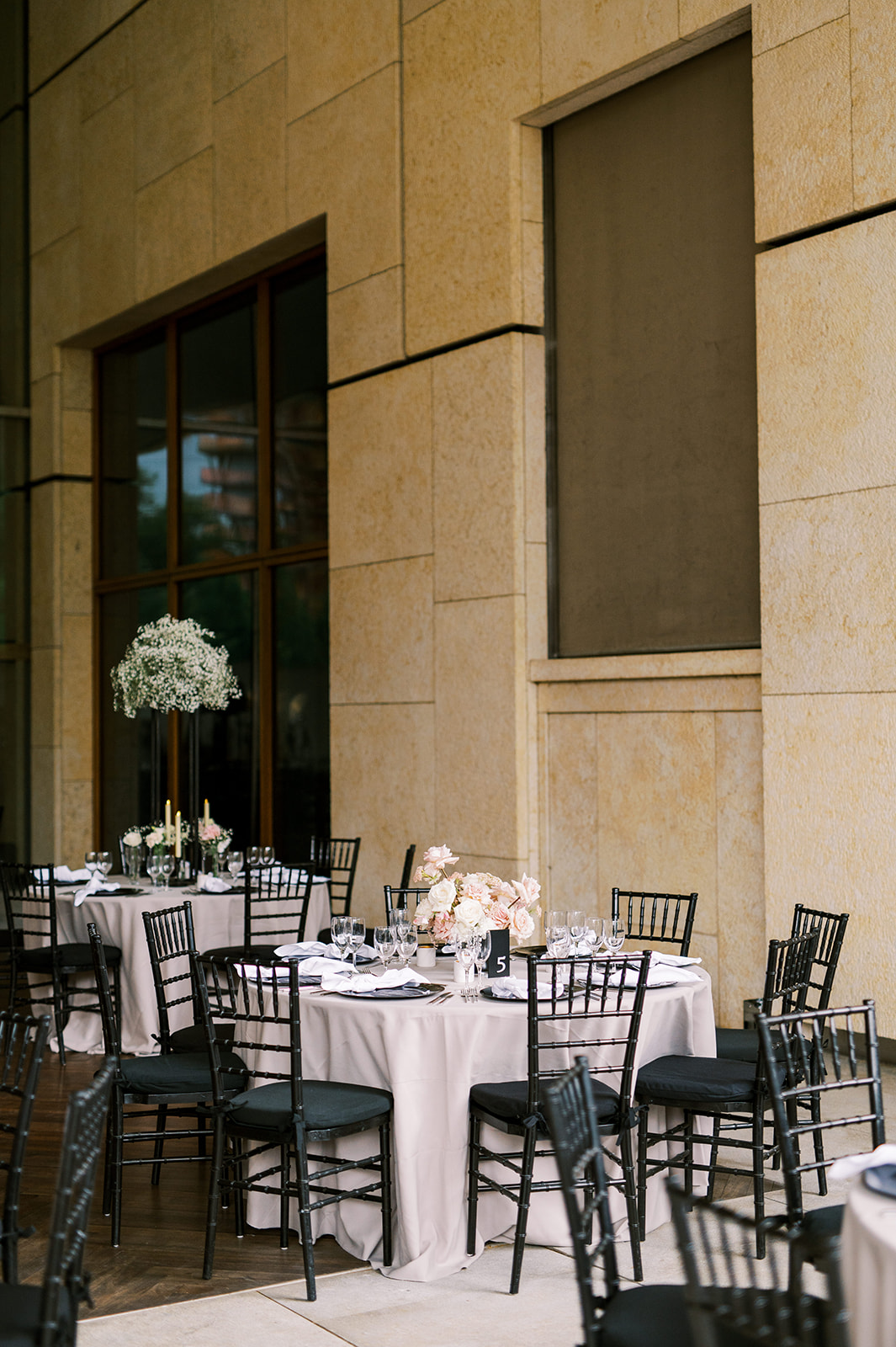 wedding reception tables with black chivari chairs at Barnes Foundation