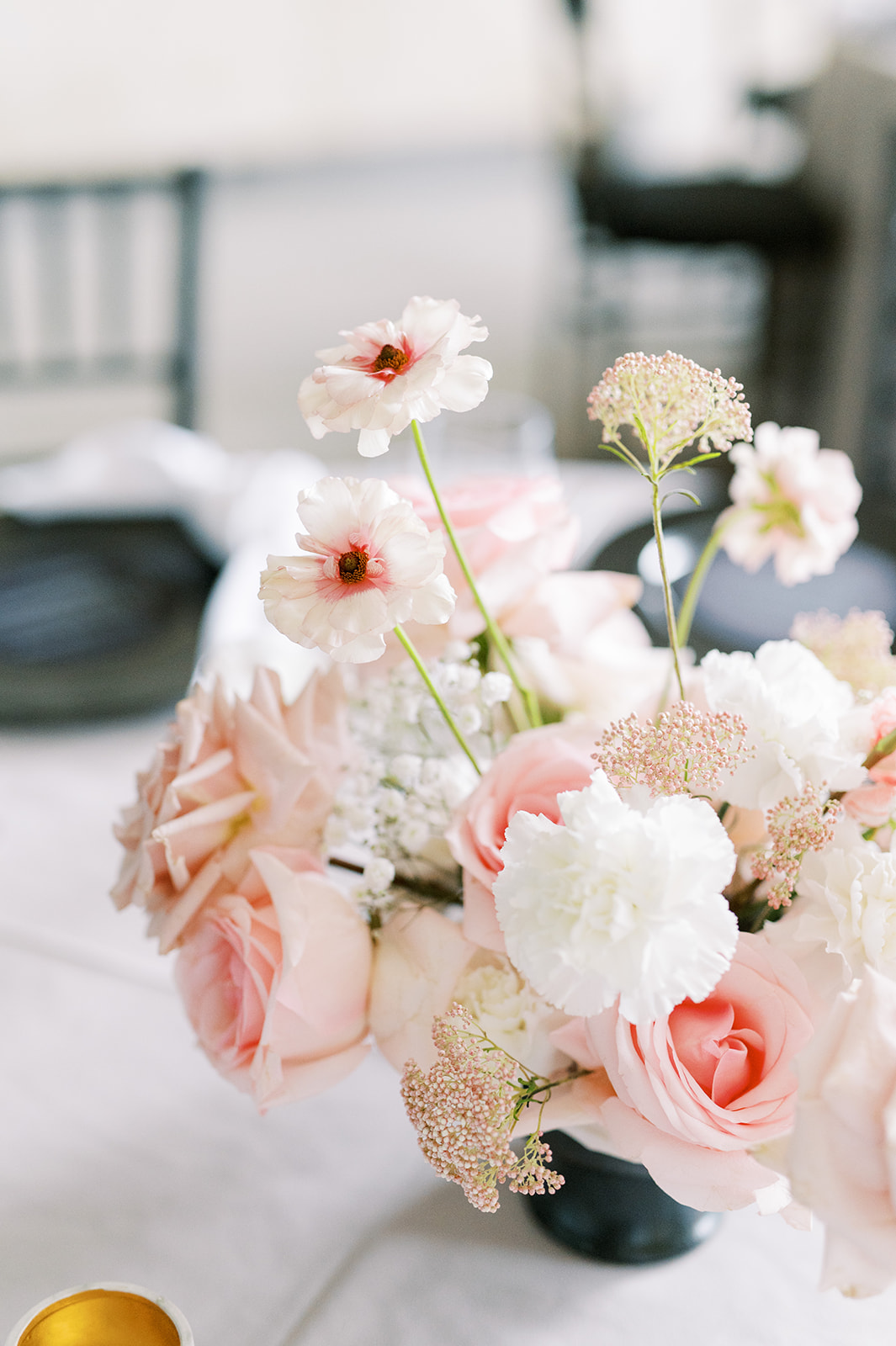 light pink and white centerpiece with black compote