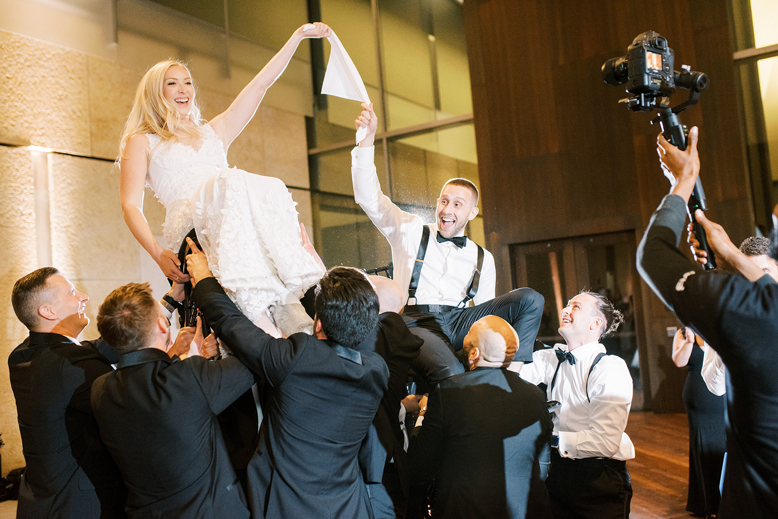 bride and groom lifted on chairs for the horah