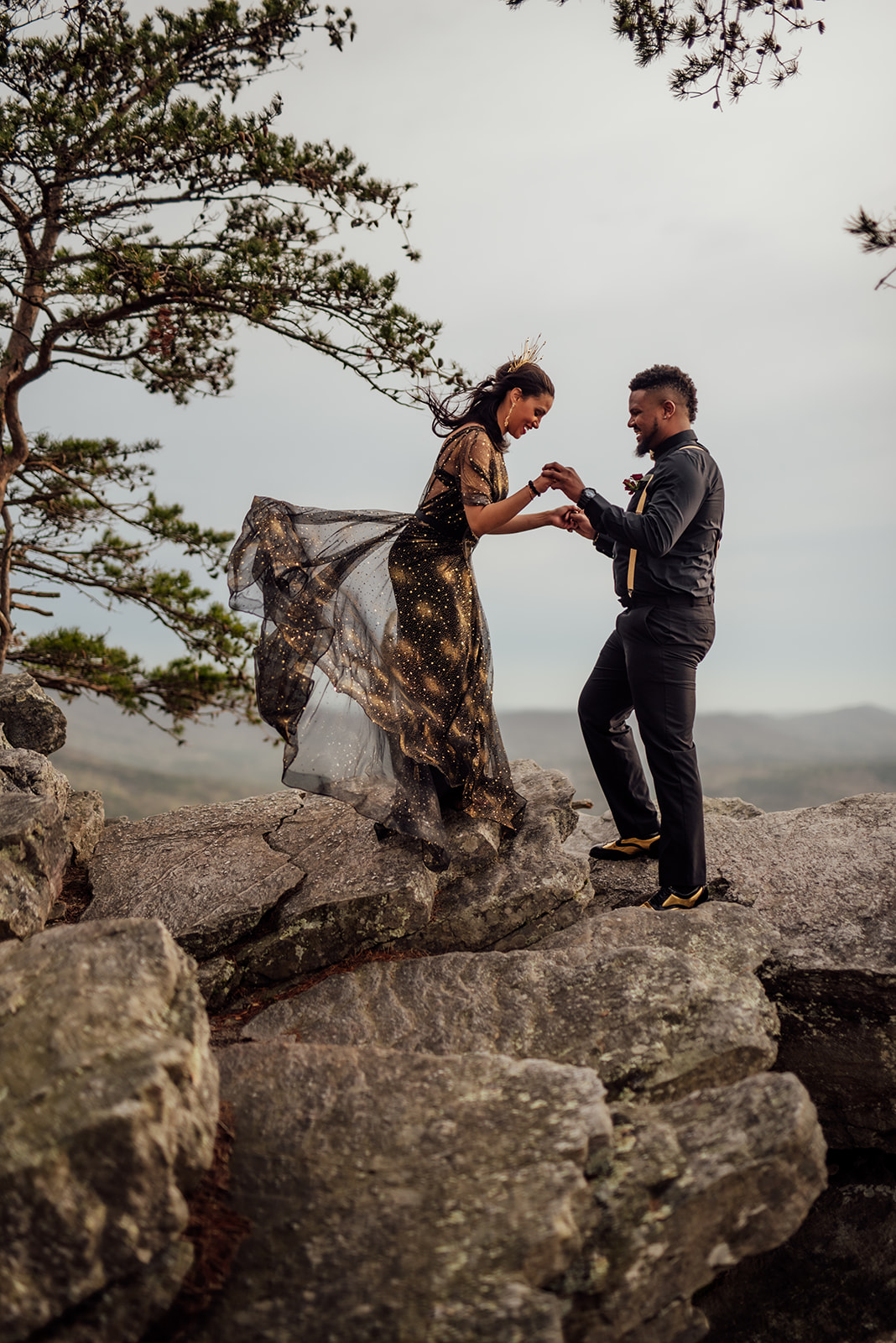 elopement couple holding hands facing each other on Mt. Cheaha