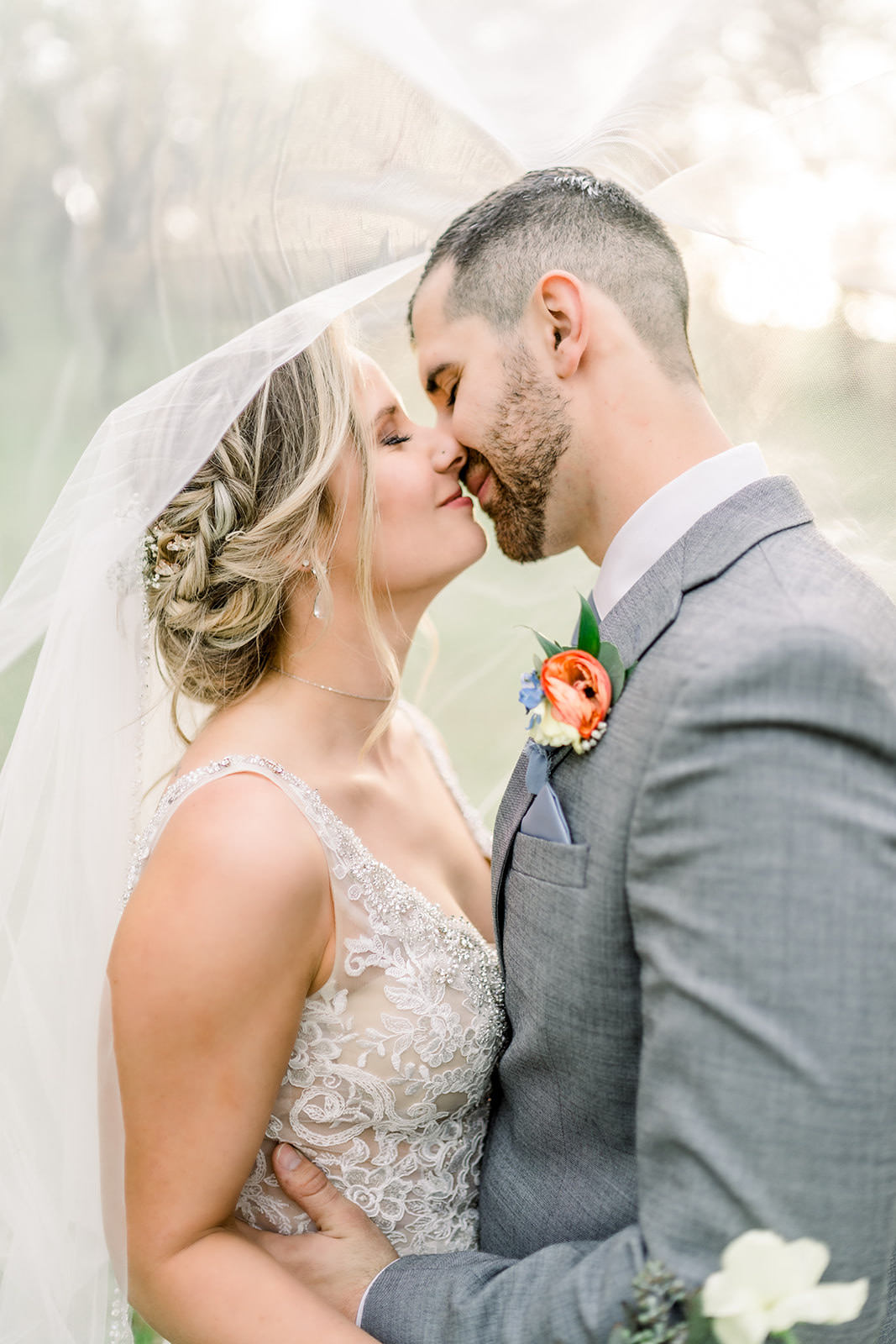 Bride and groom kiss under veil in northern CA