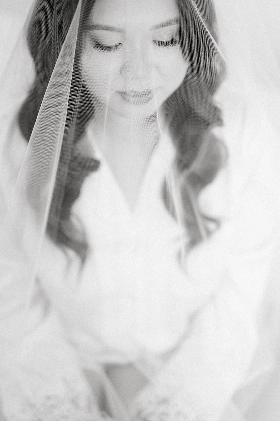 black and white photo of bride under her veil