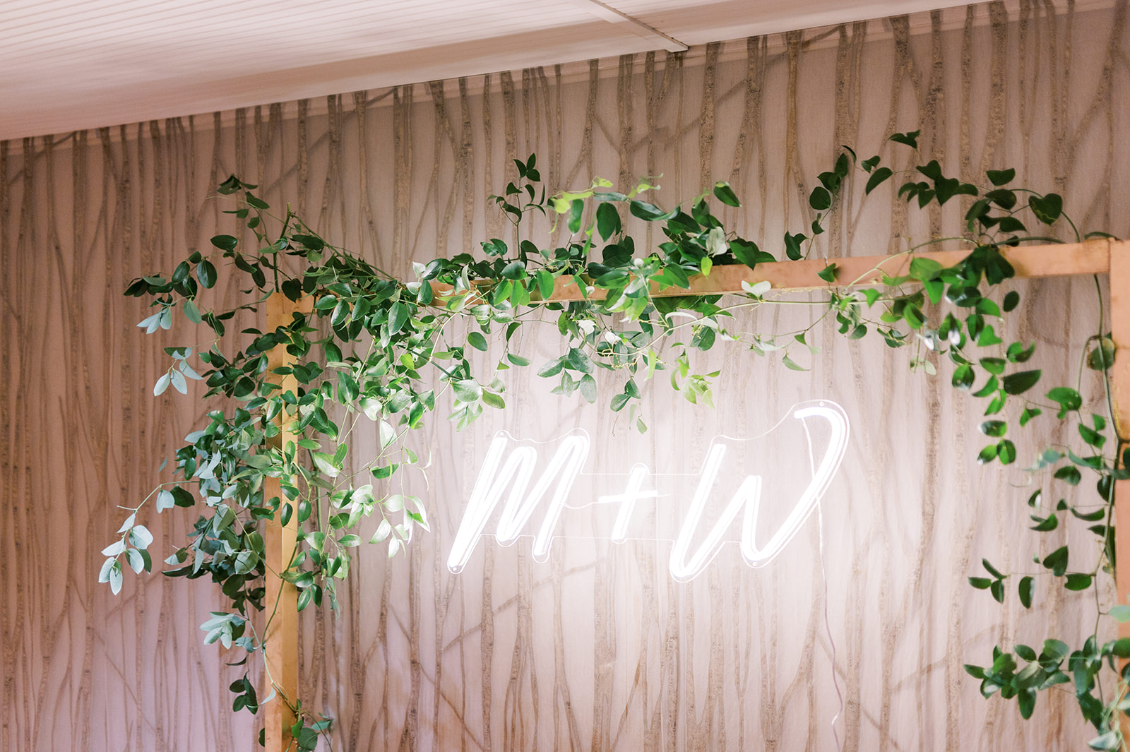 neon monogram sign with greenery for wedding photo booth at Pomme in Radnor, PA