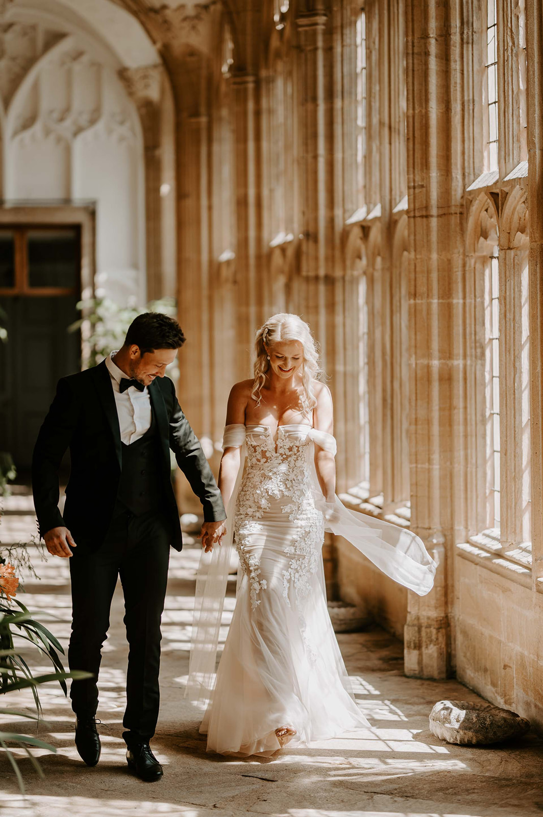 bride and groom walking through orangery at ford abbey
