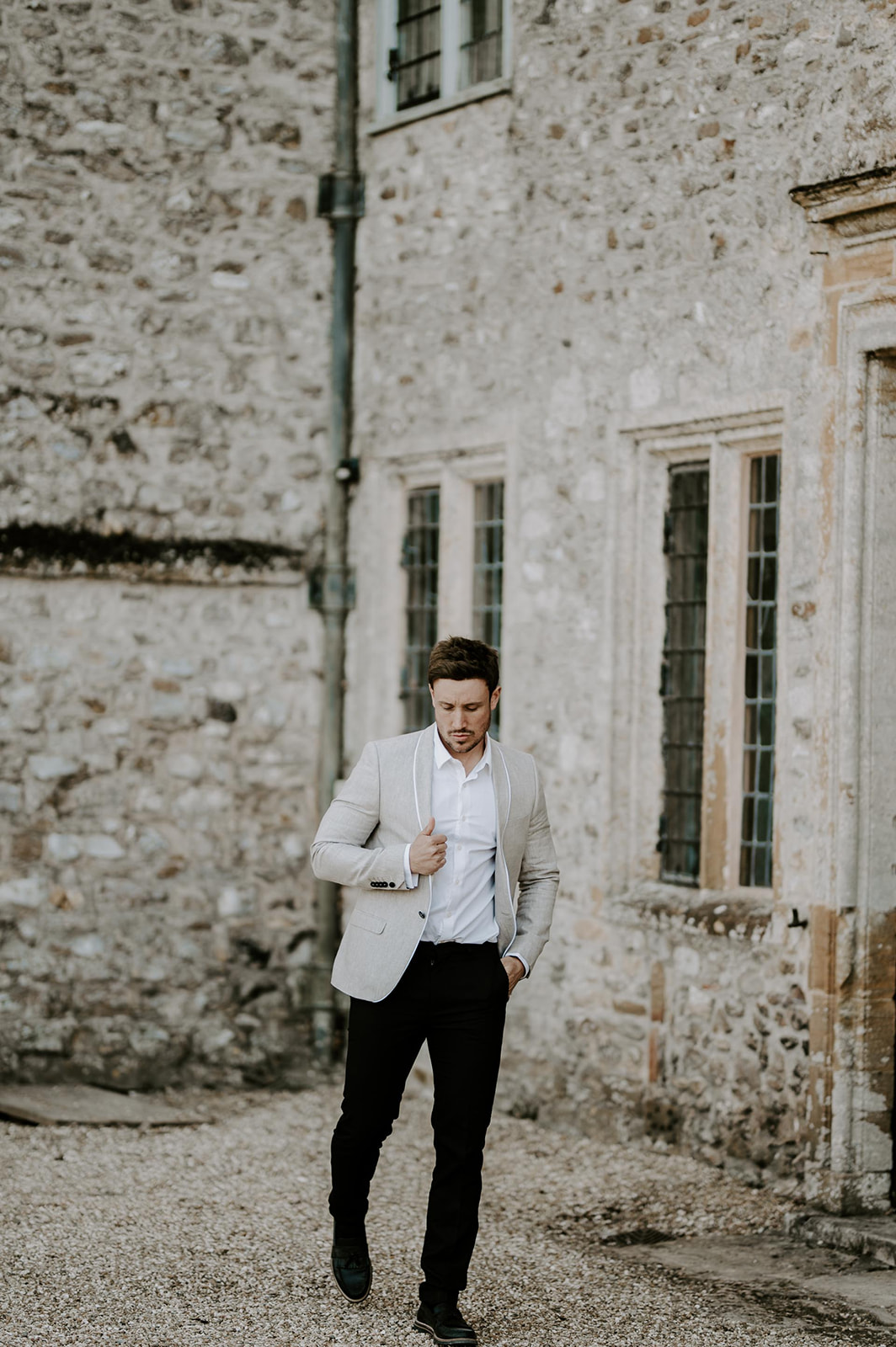 groom wearing white suite jacket walking