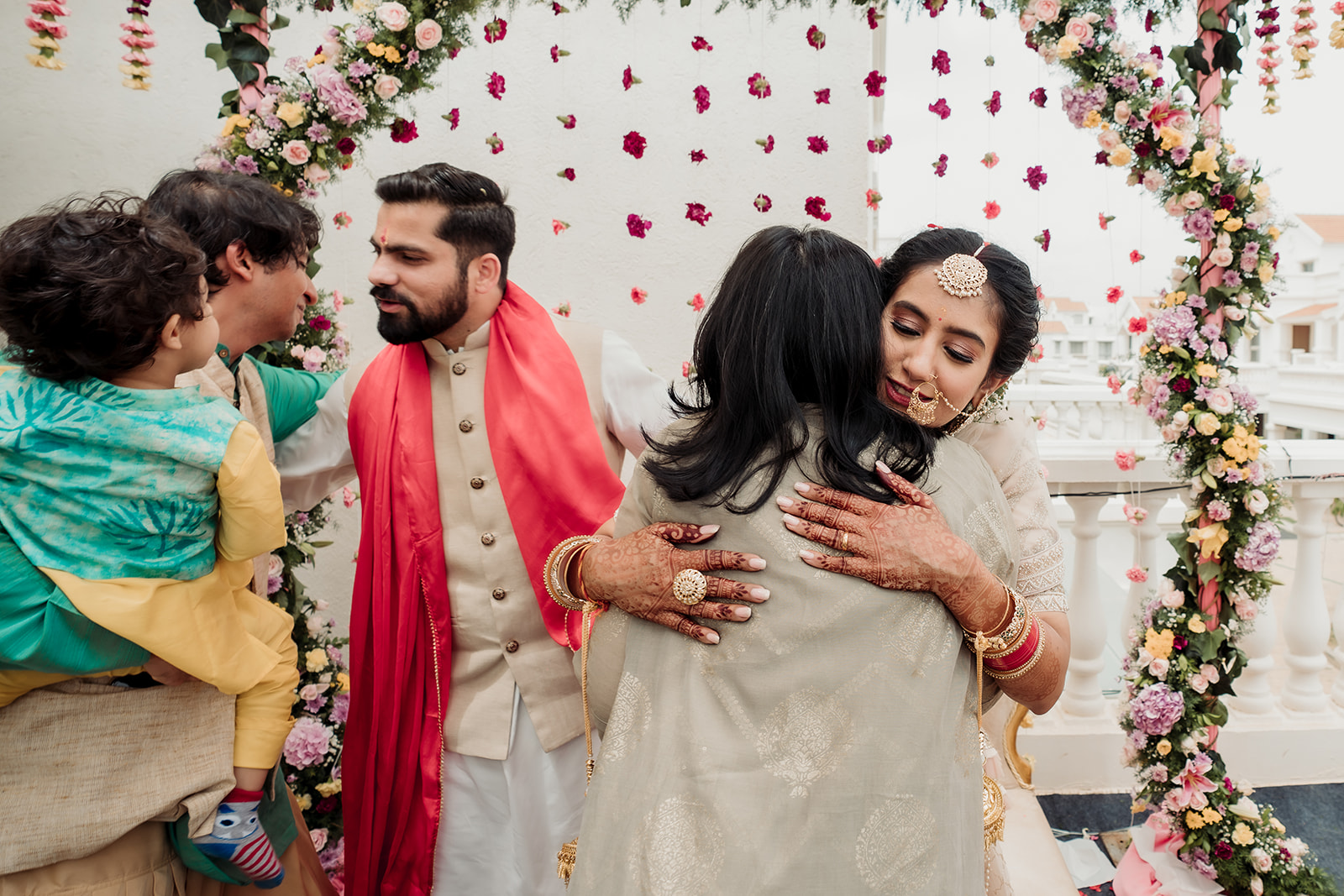 Sibling embrace: A heartwarming moment as the bride shares a warm hug with her beloved siblings.