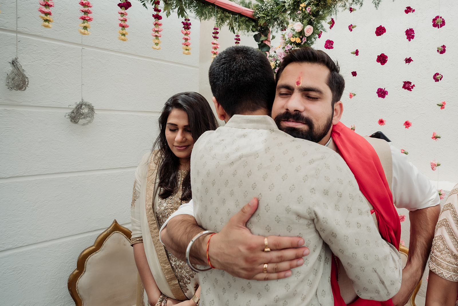 Family ties: The groom cherishes a sweet moment with his siblings, enveloped in a warm and loving hug