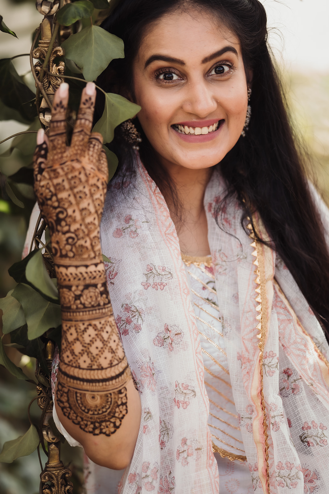 "Henna beauty: Bride displays the artistry of her mehendi in a captivating and elegant pose.