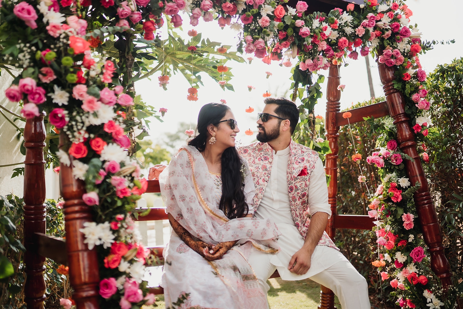 Cultural celebration: The bride and groom pose amidst intricate mehendi decorations, adding beauty to the ceremony.