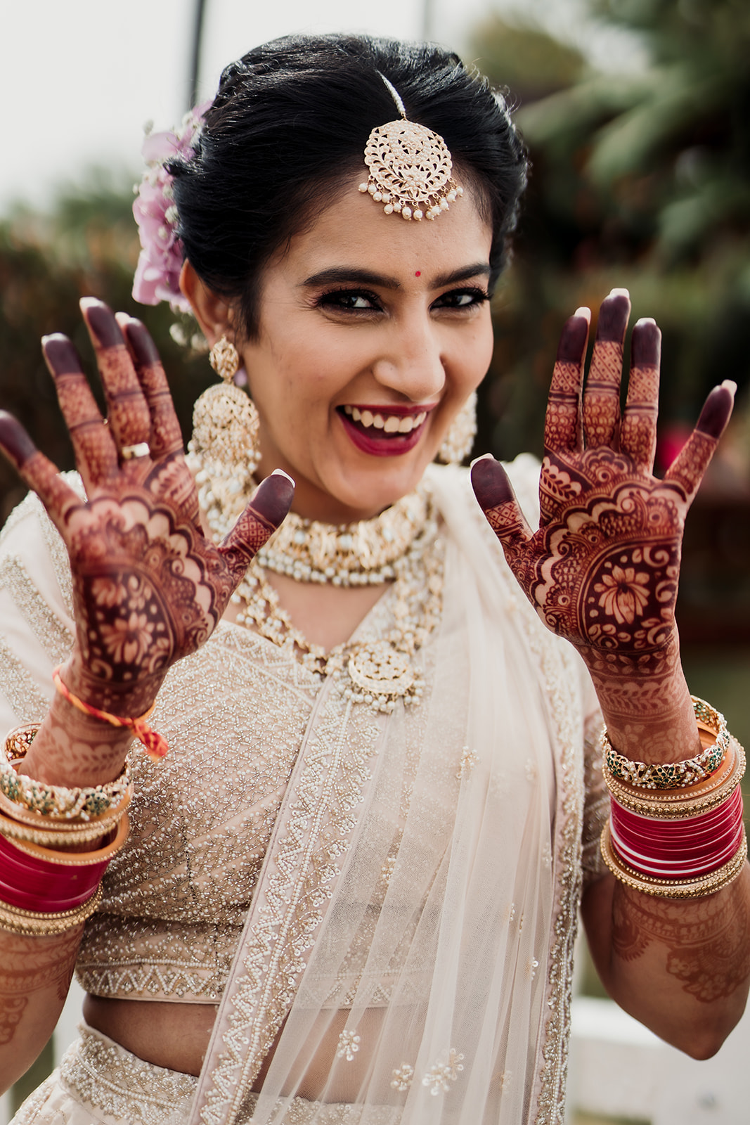 Artistic expression: The bride revels in the beauty of her mehendi stain, a testament to cultural tradition and bridal a