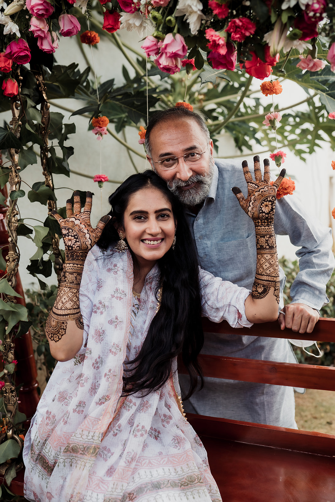 Mehendi elegance: The bride showcases intricate mehendi designs on her hands in a beautiful image.