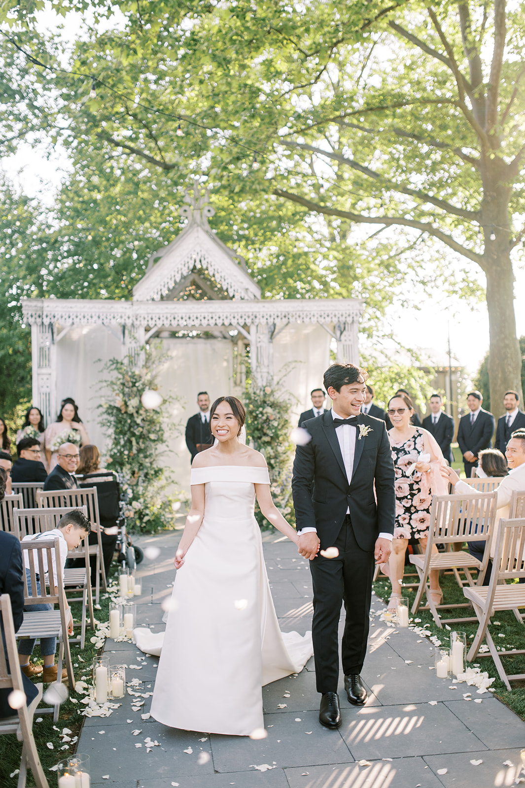 bride and groom celebrate as they leave their romantic boho wedding with lush florals at terrain at styers