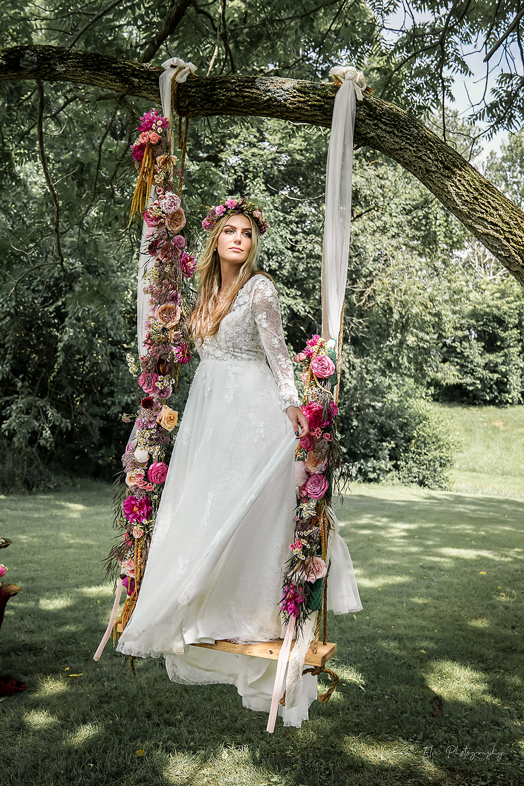 bohemian bride on swing wearing dress by Lace Bridal Couture flowers by Kindly Grown at Cedar Bay Farm