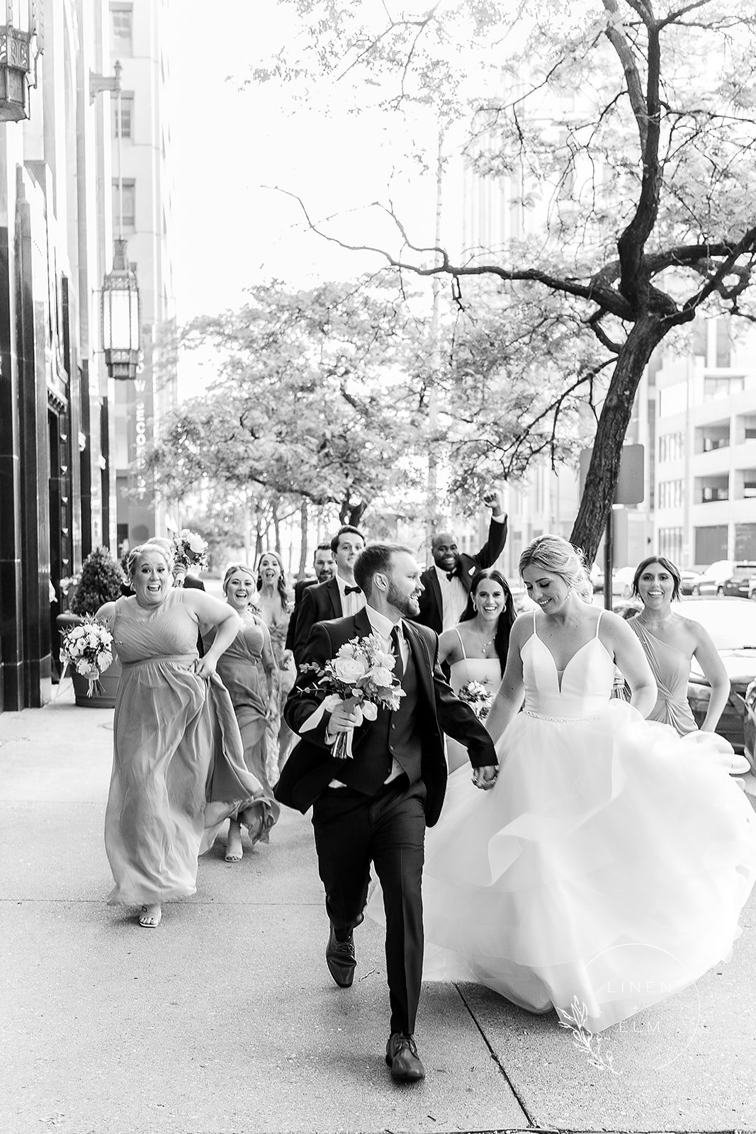 bridal party running down the street cincinnati wedding photography 