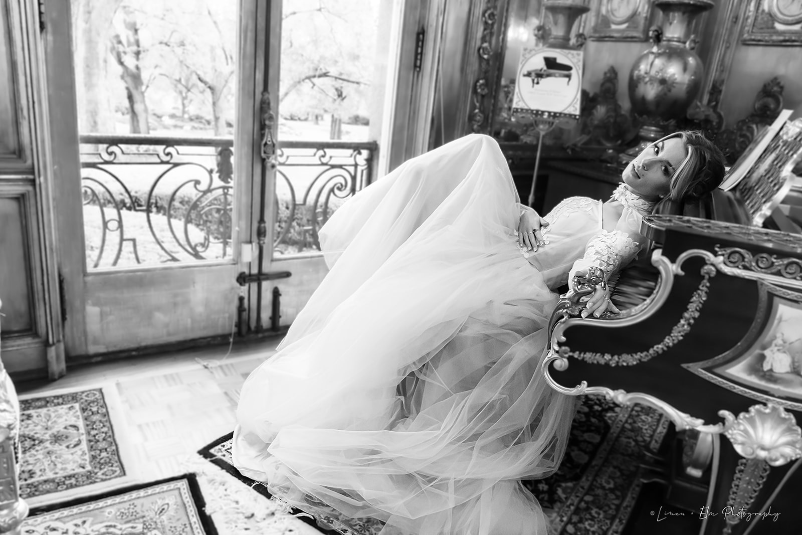 bridal portrait black and white bride leaning on piano