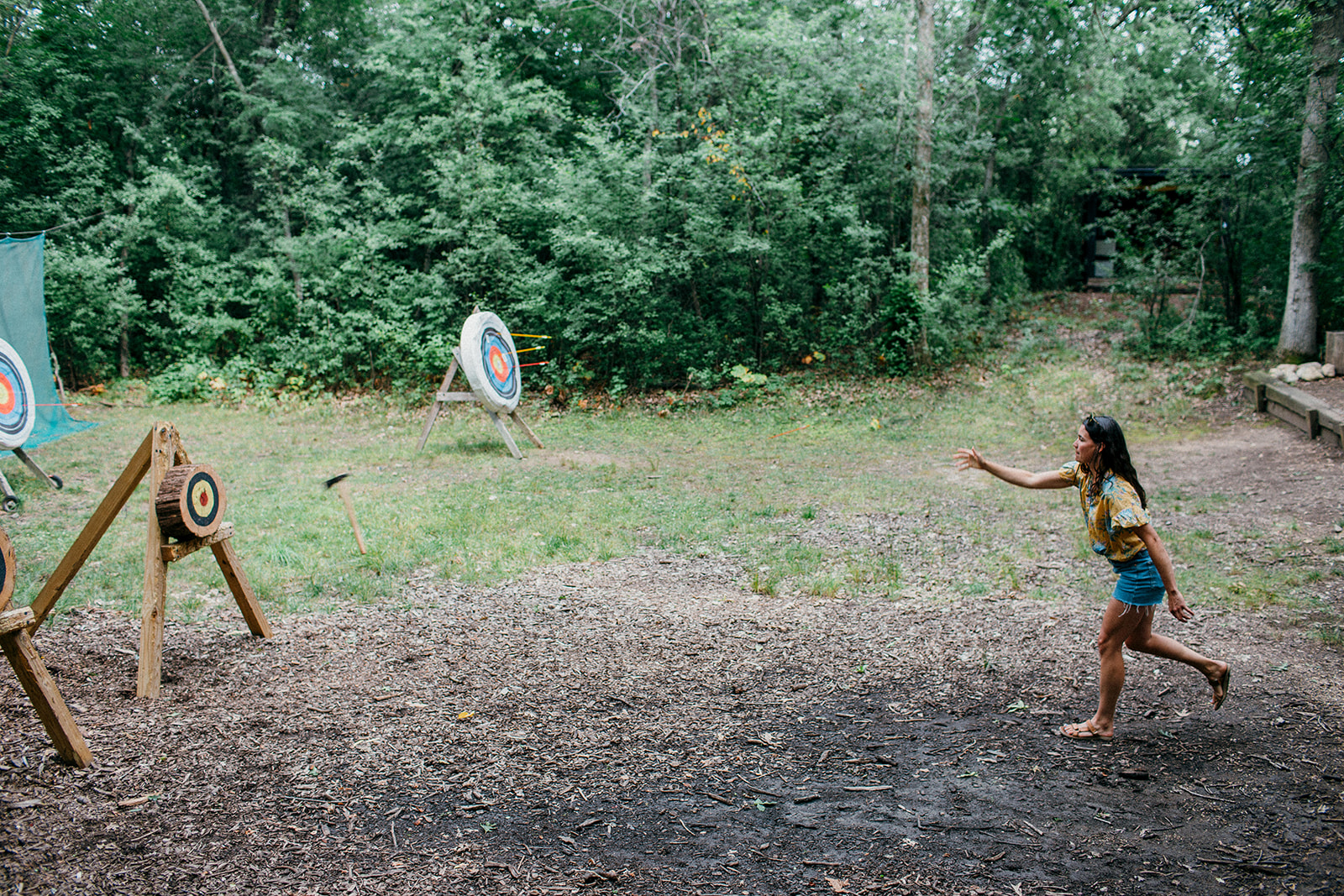 Hatchet and axe throwing at Camp Wandawega during a wellness wedding weekend