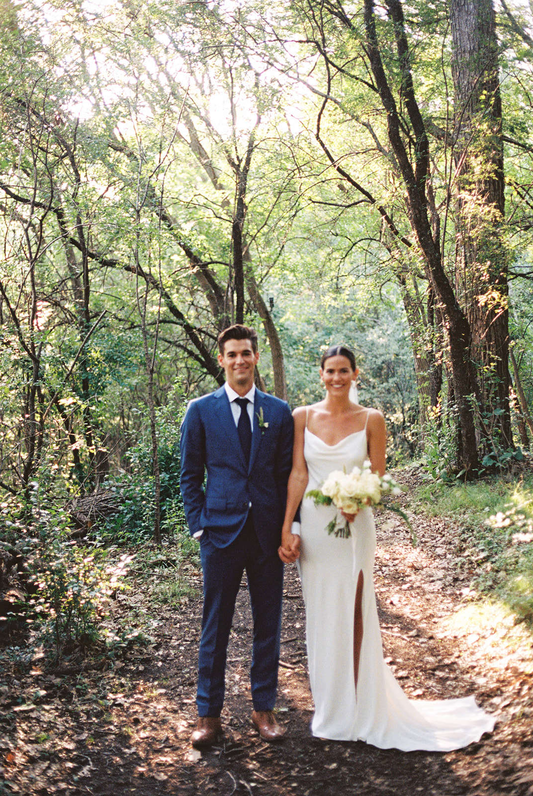 Wedding couple on film in dreamy forest light at Camp Wandawega