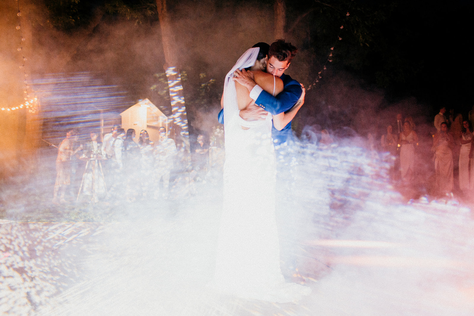 Wedding couple shares a first dance in some smoke and light show under the treehouse at Camp Wandawega