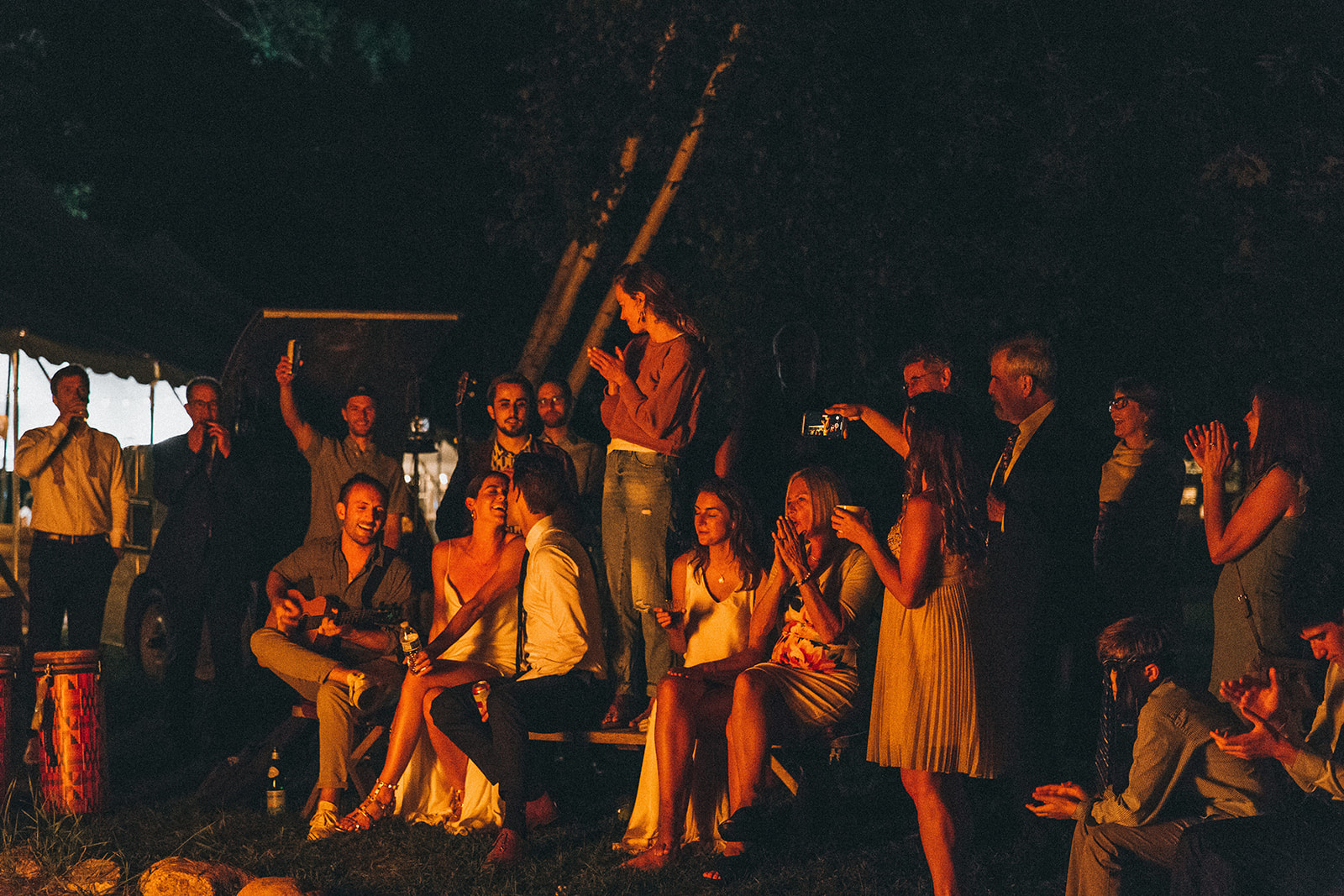 Wellness wedding ends the weekend with everyone surrounded around a blazing fire at Camp Wandawega