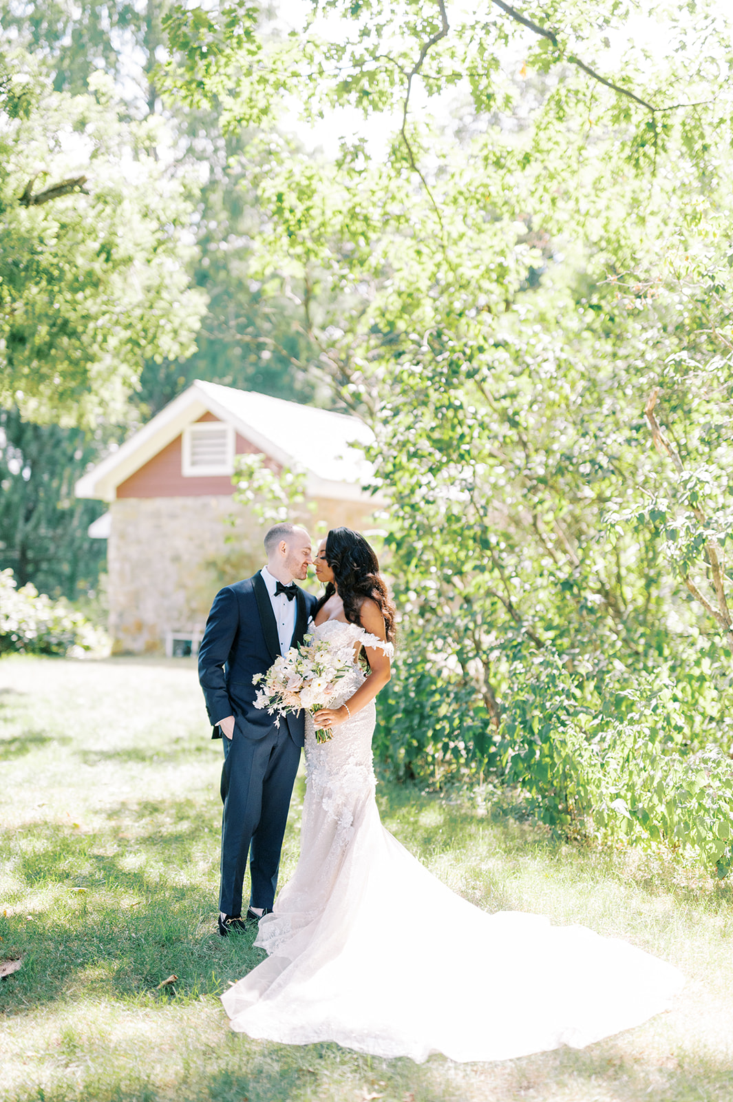 bride and groom embrace on sunny lawn at Summer Crossed Keys Estate Wedding by Haley Richter Photography