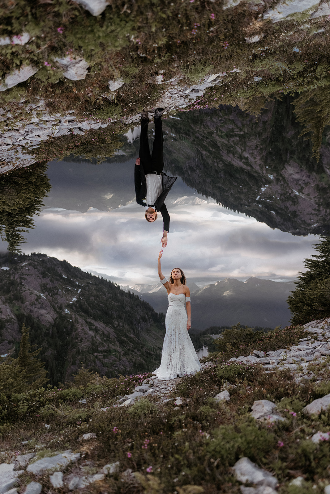 A bride and groom reaching their hands towards each other during their North Cascades elopement at Artist Point.