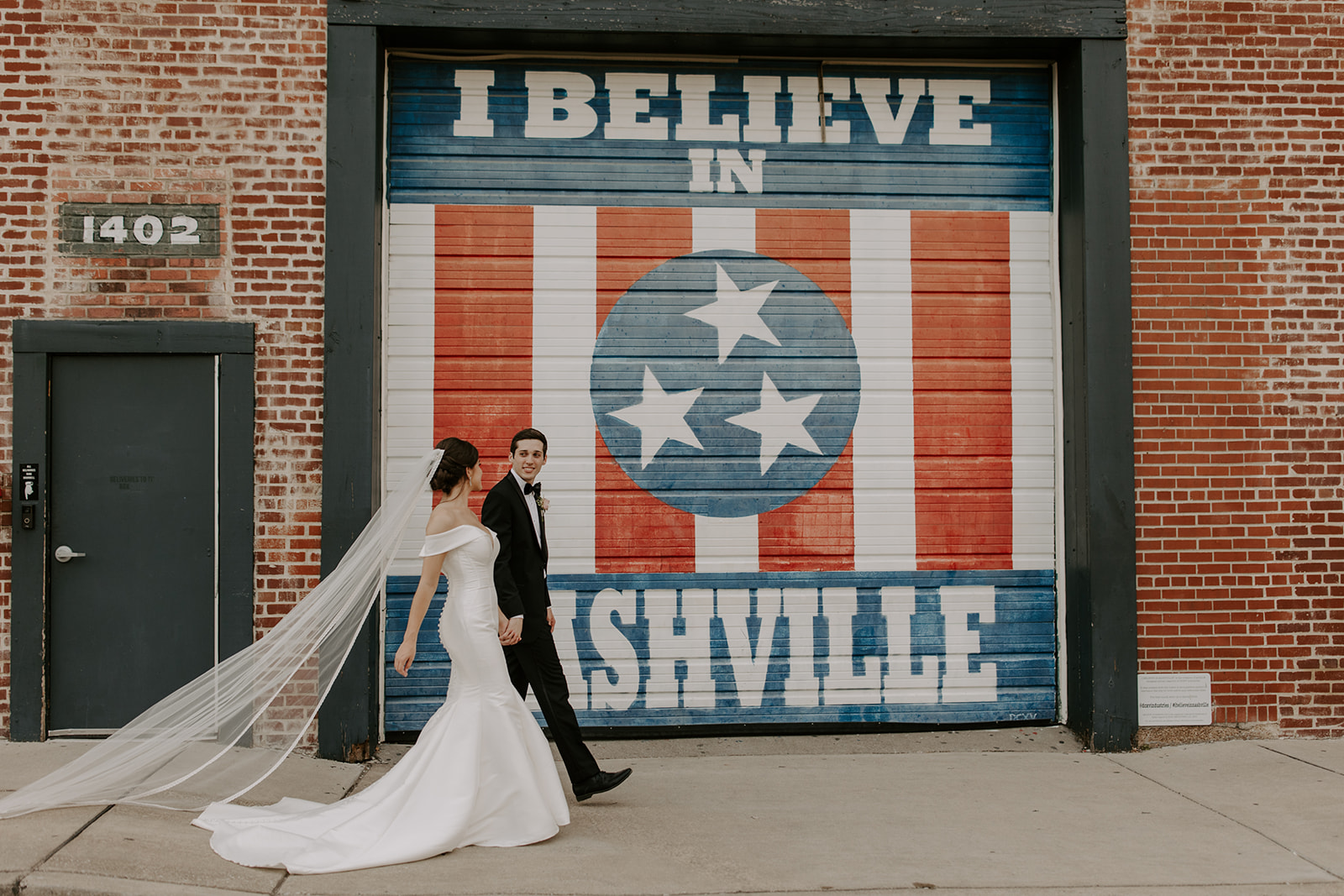 Candid, documentary street photos of couple in front of I Believe in Nashville Sign at Marathon Village