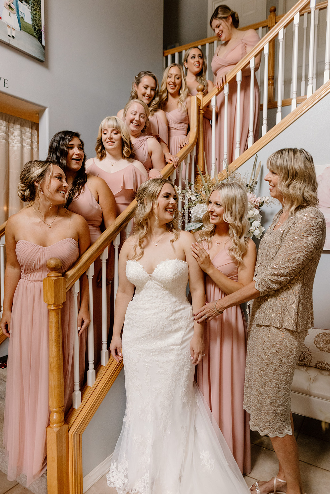 A bride getting dressed with her mom and bridesmaids at her Creekside Estate wedding. 
