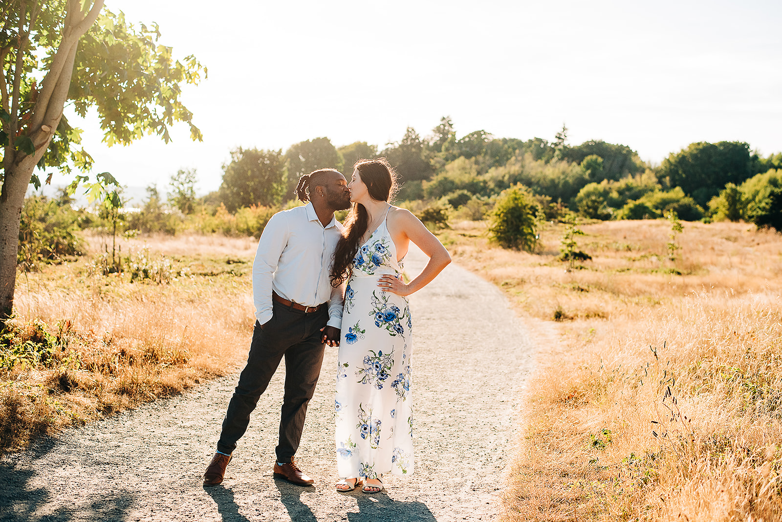 An interracial couple is photographed for their engagement session at Discovery Park in Seattle, WA