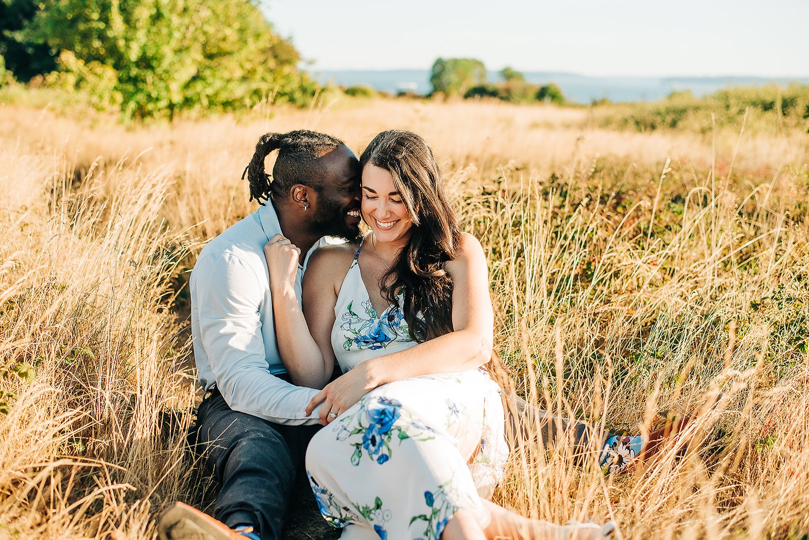 An interracial couple is photographed for their engagement session at Discovery Park in Seattle, WA