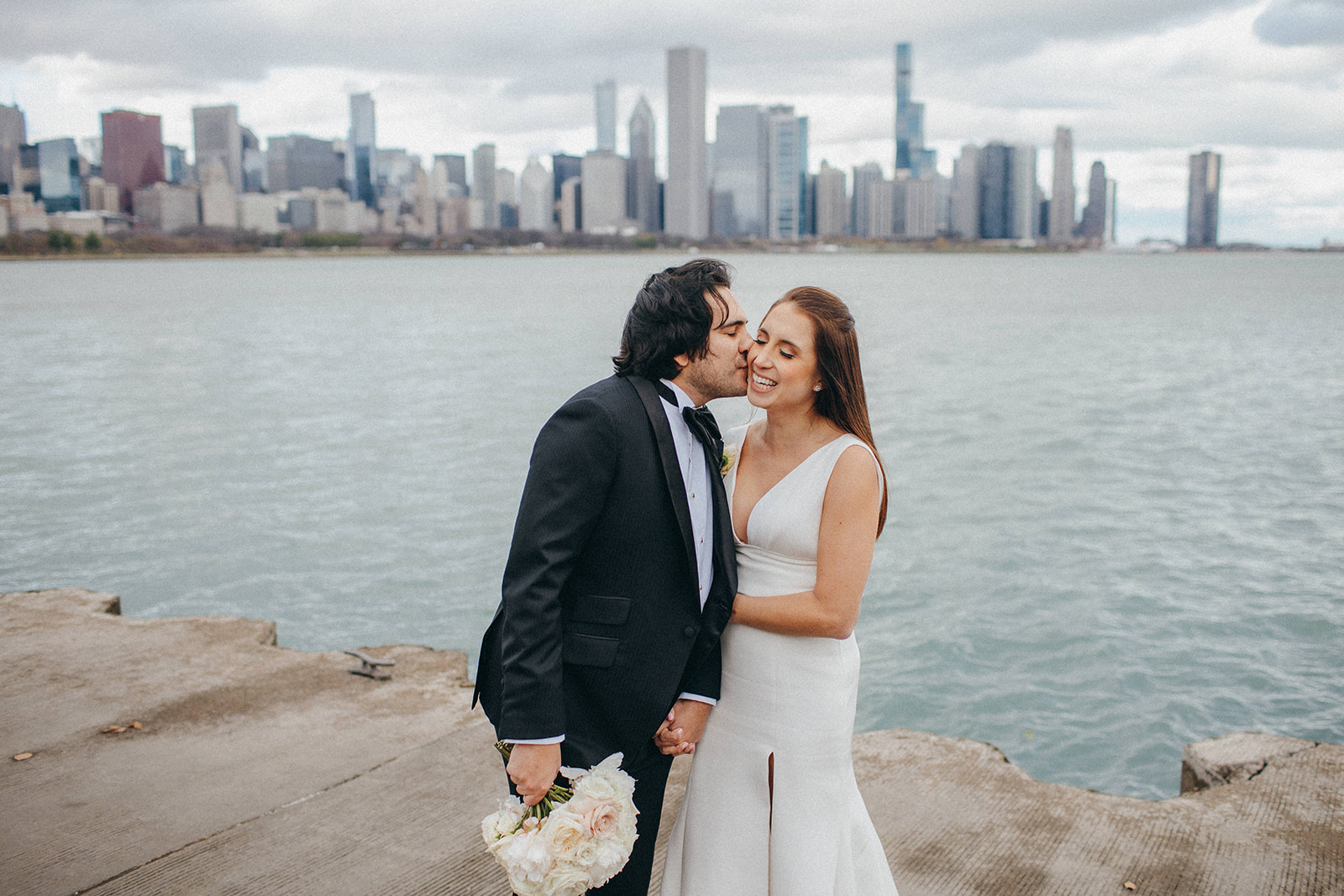Black tie wedding portraits on Lake Michigan in front of the Chicago Skyline