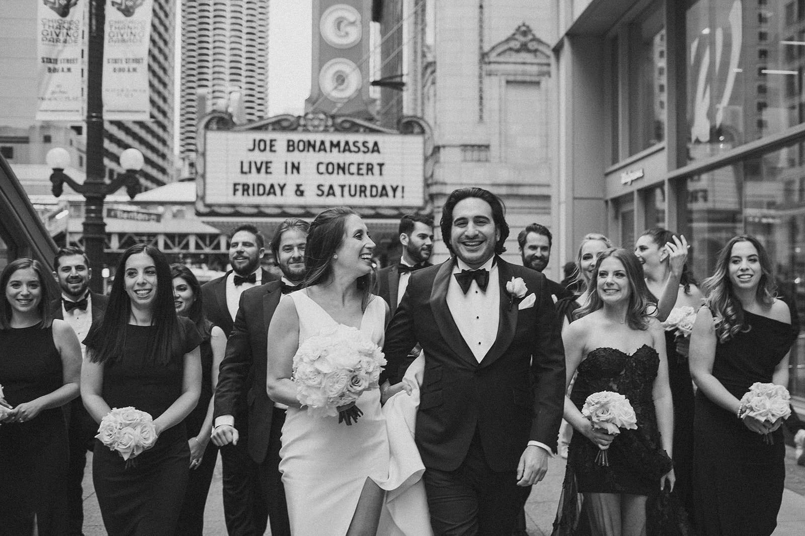 Wedding party hangs out in downtown Chicago by the Chicago Theatre