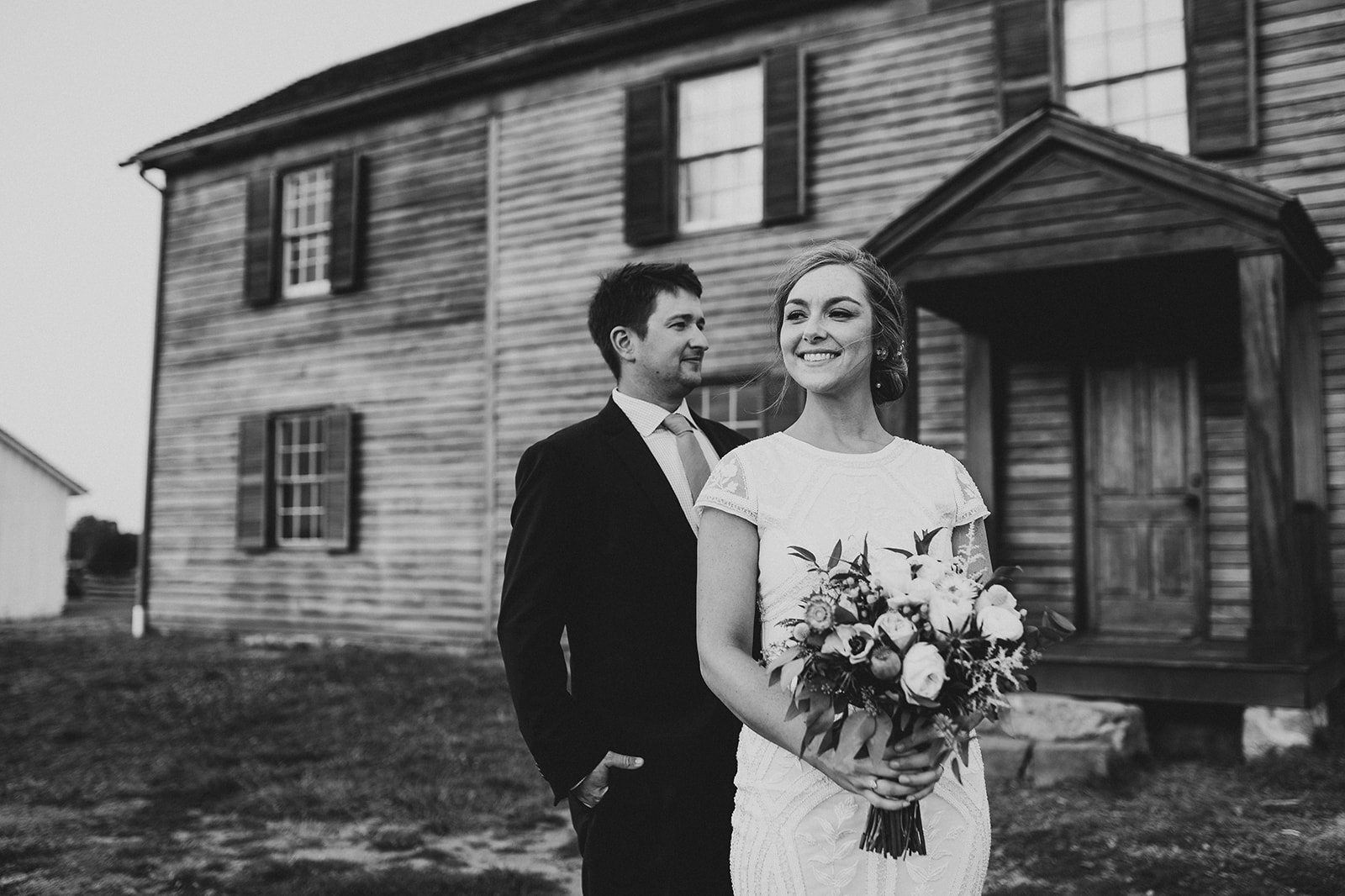 Candid shot of the bride and groom sharing a tender moment during their elopement photoshoot at Manassas Battlefield Par