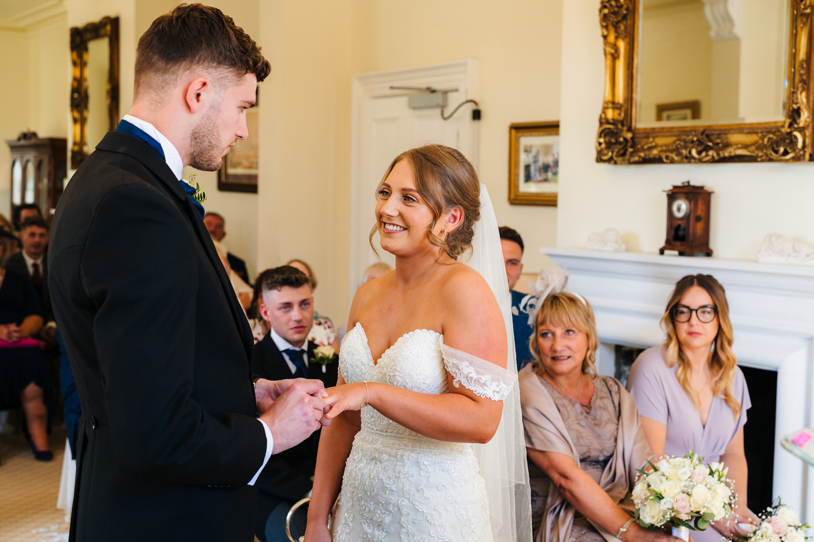 Shottle Hall Wedding Photography - bride and groom, exchanging wedding rings
