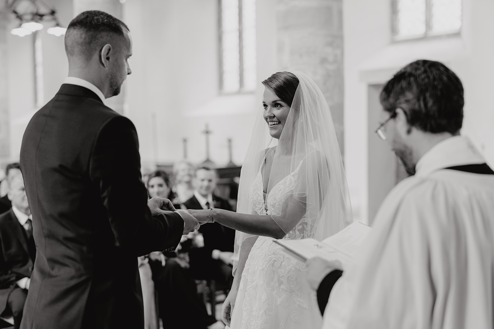 Bride and groom exchange rings during their wedding ceremony

