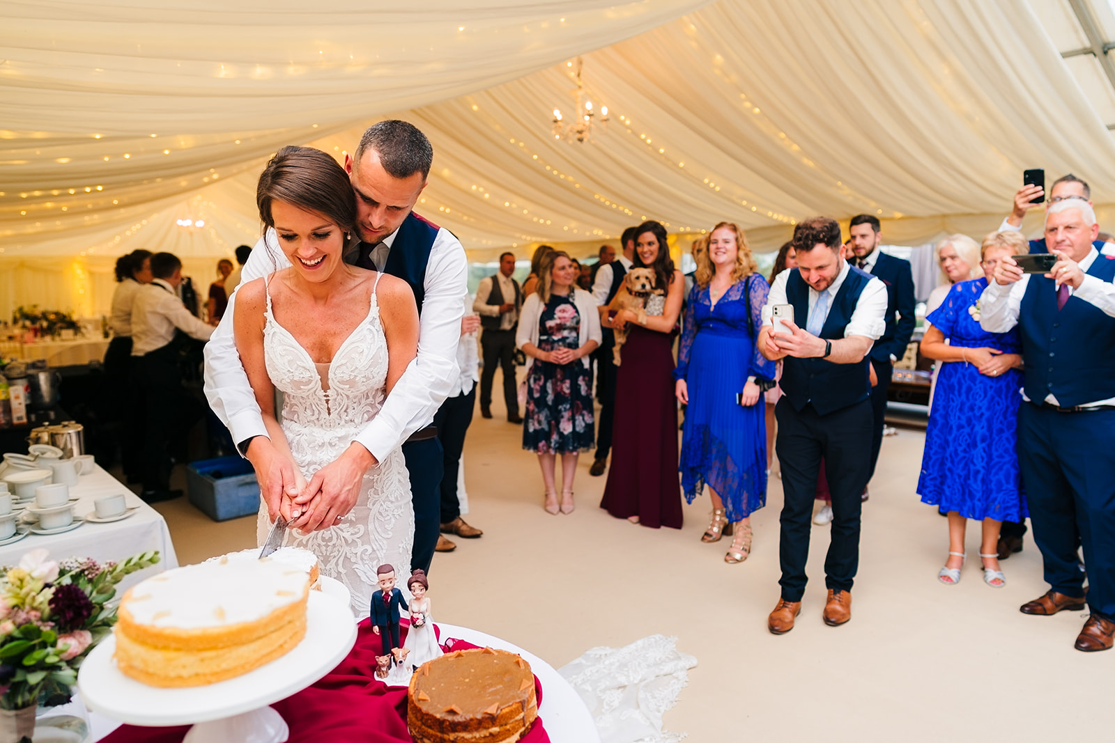 Langar Church Wedding Photography + bride and groom cutting the cake

