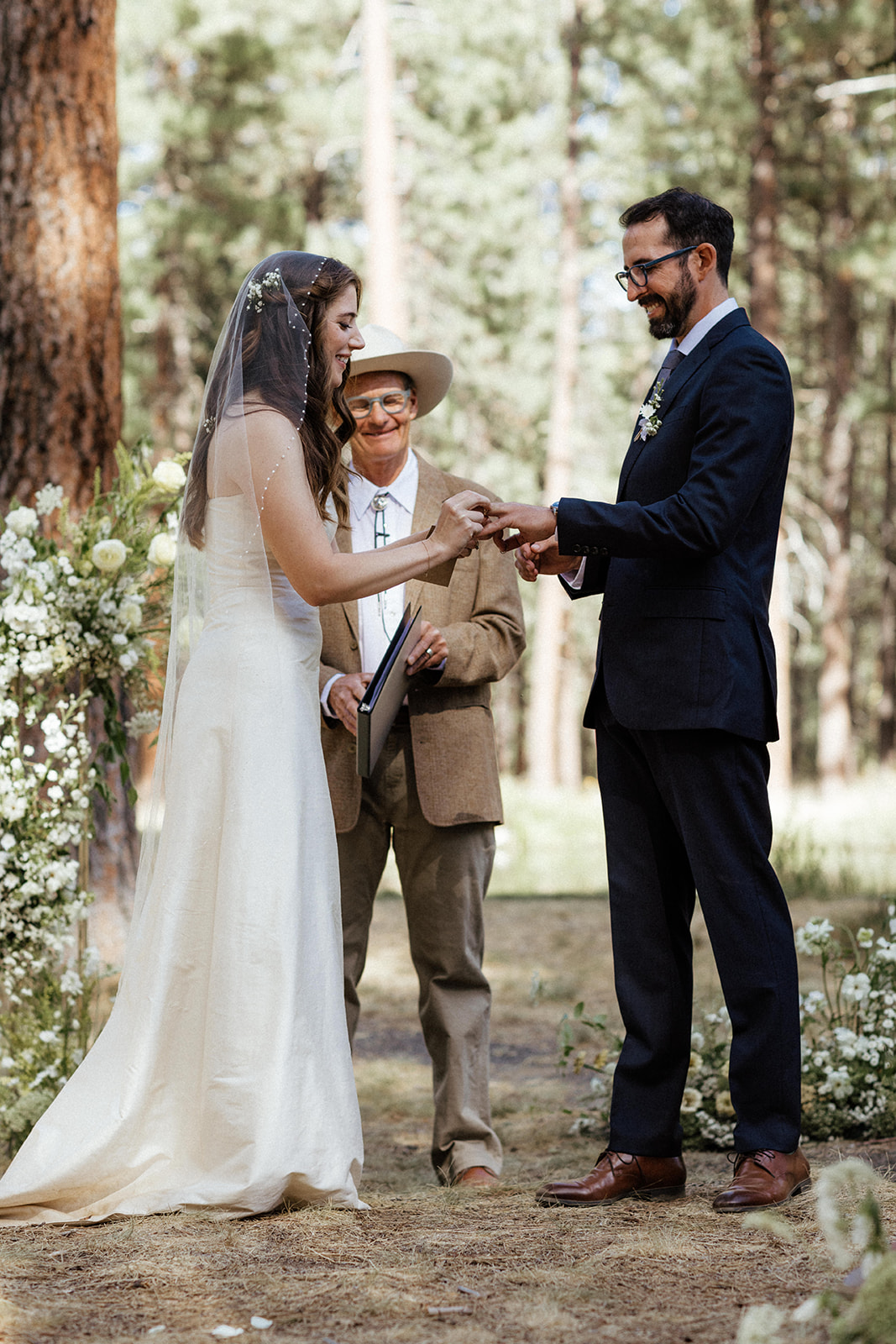 bride and groom ring exchange at lake creek lodge