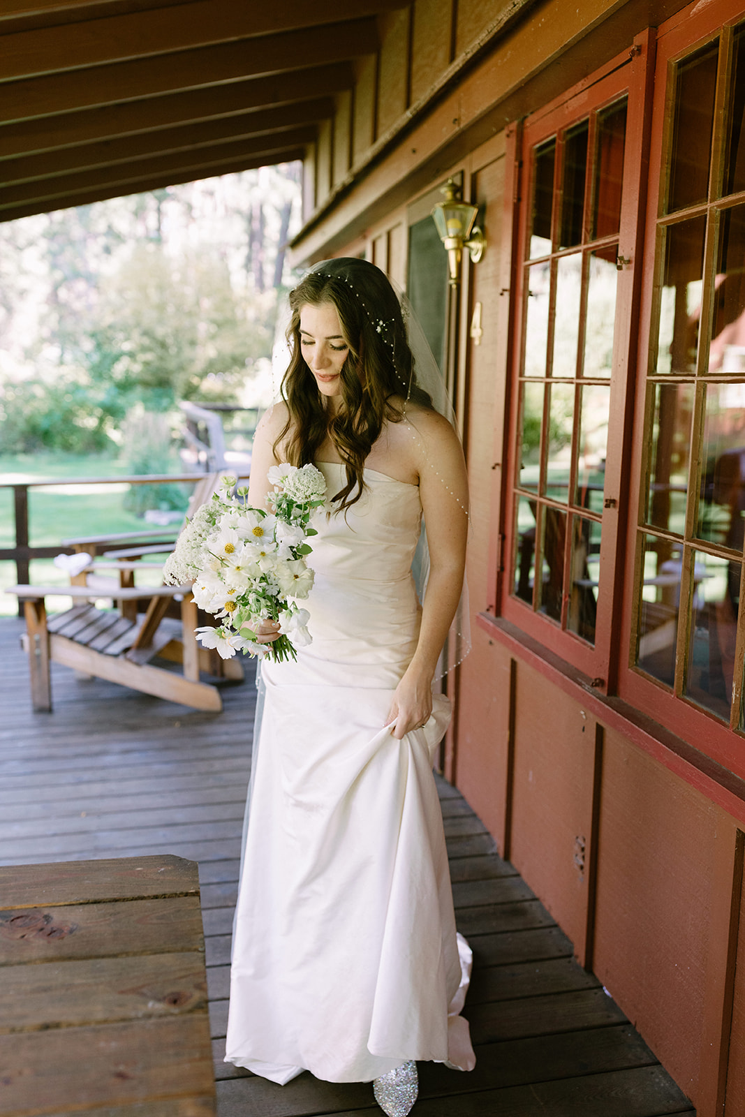 bride looking down at bouquet at lake creek lodge