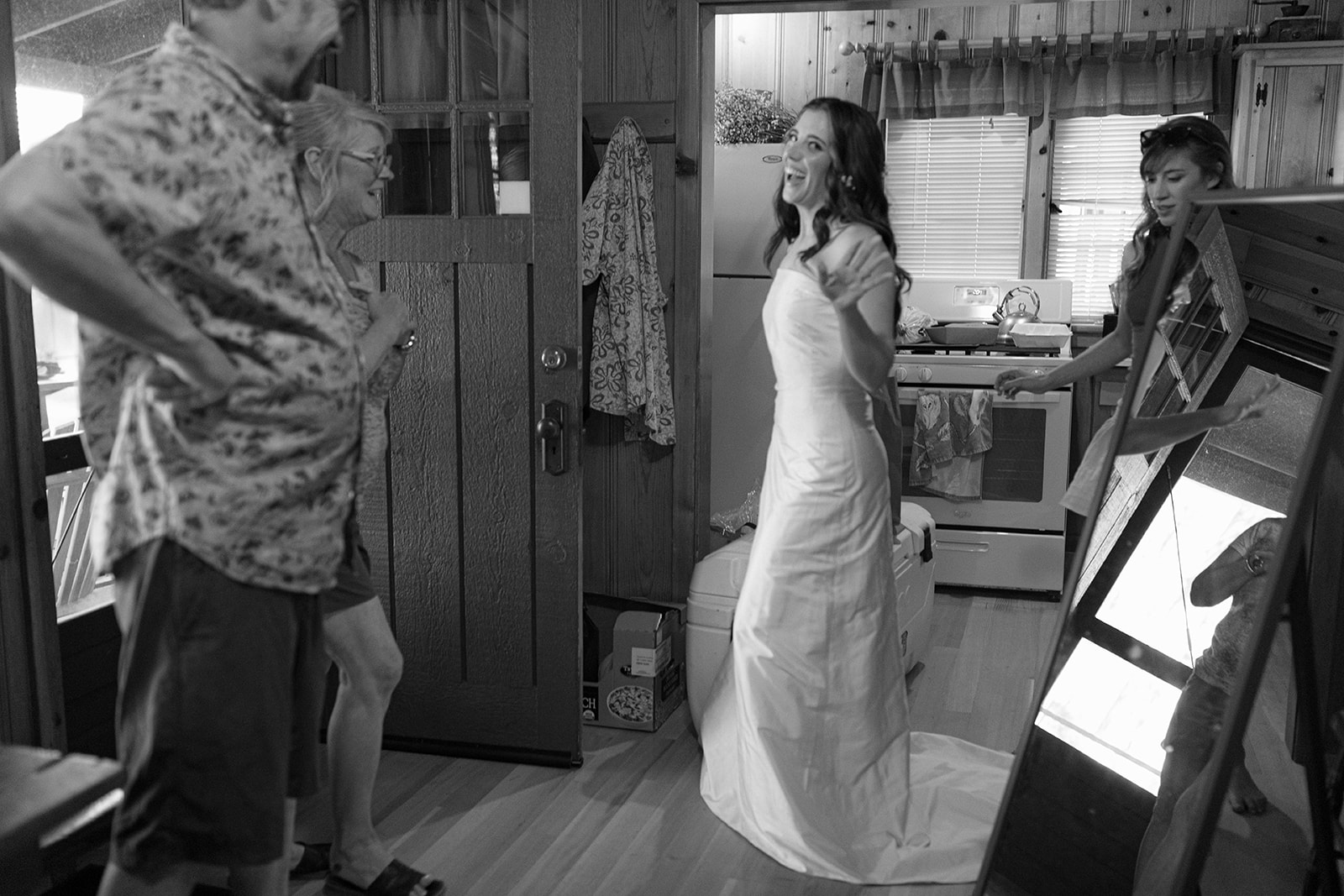 bride waving to the camera after getting dressed in cabin