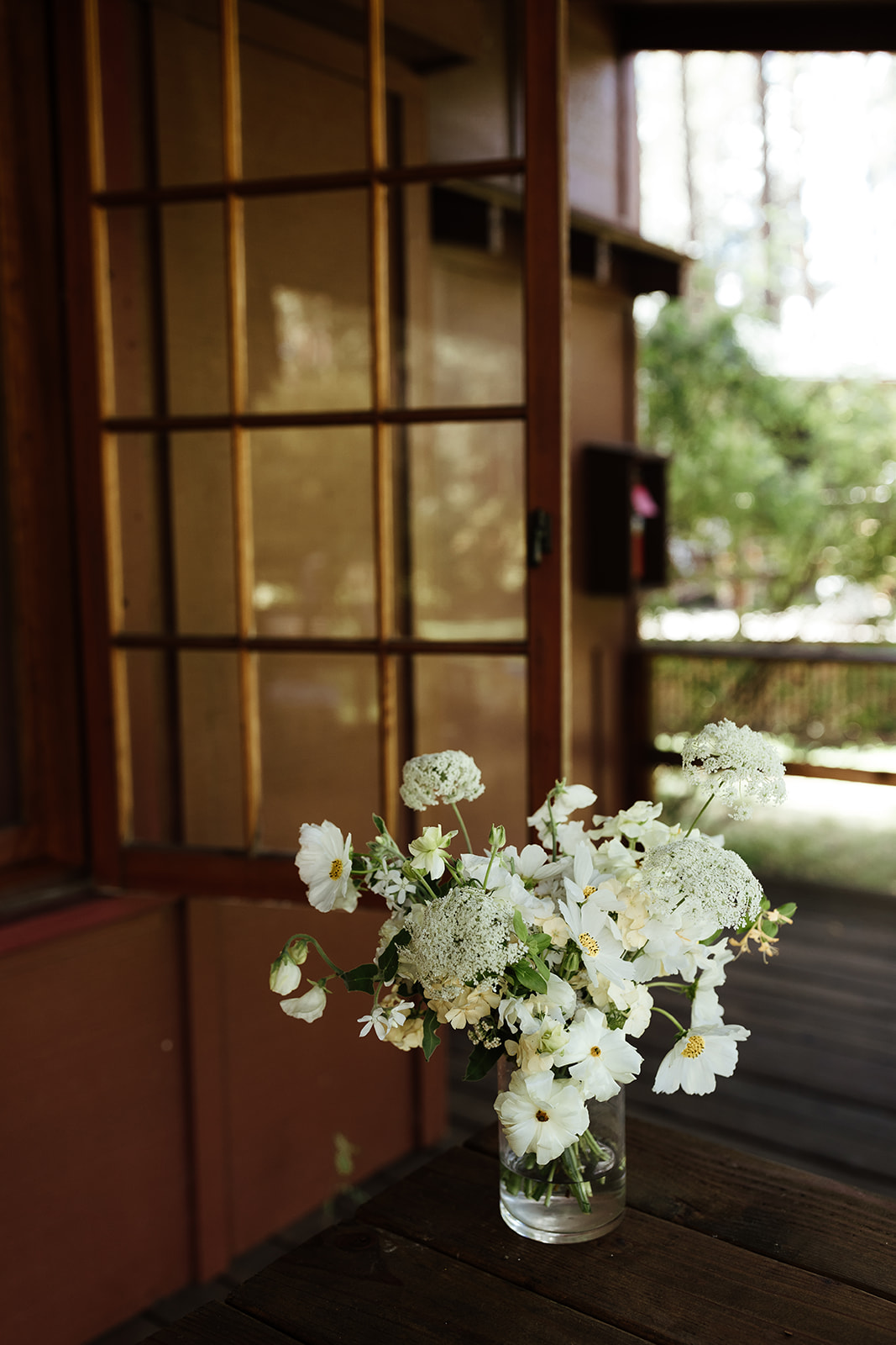wedding bouquet on table in front of cabin