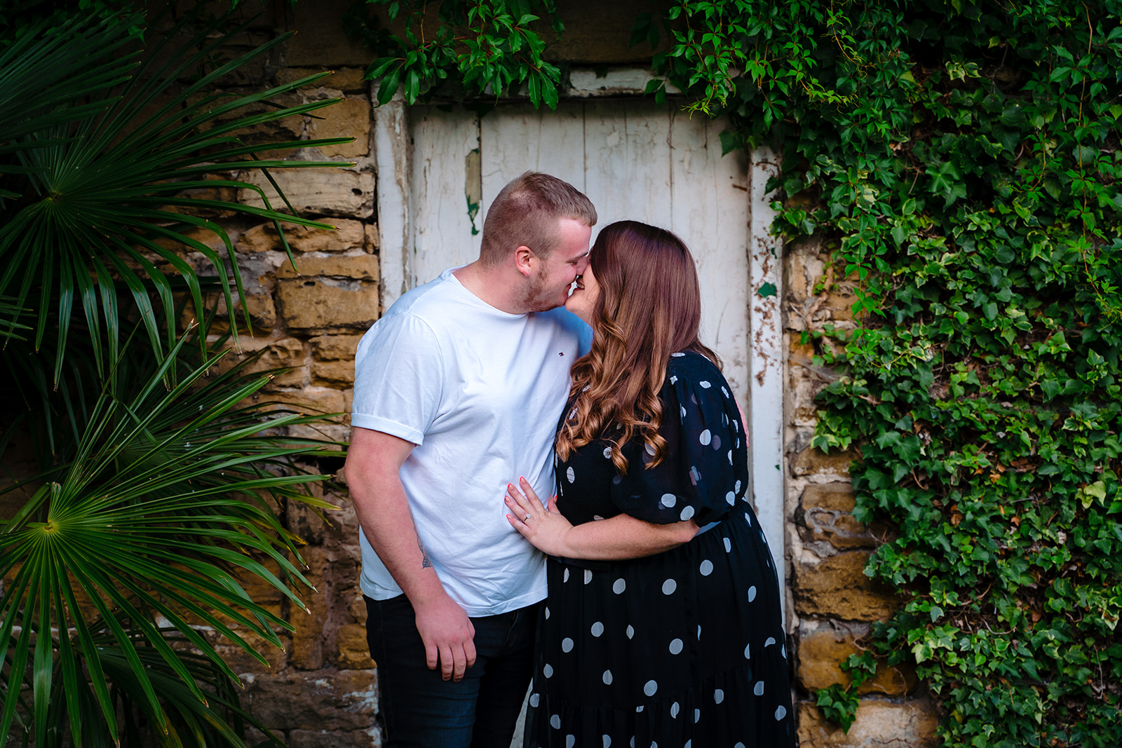couple kiss in the walled garden at Hooton Pagnell