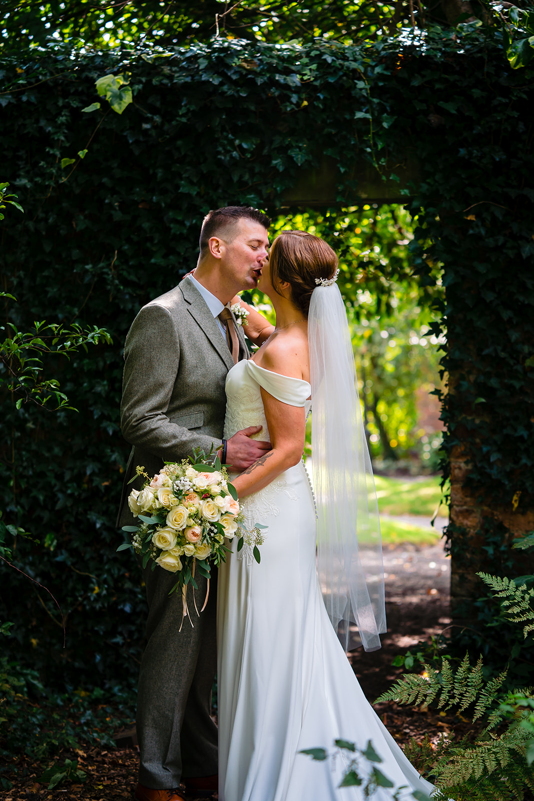 bride and groom kiss at Bartle Hall
